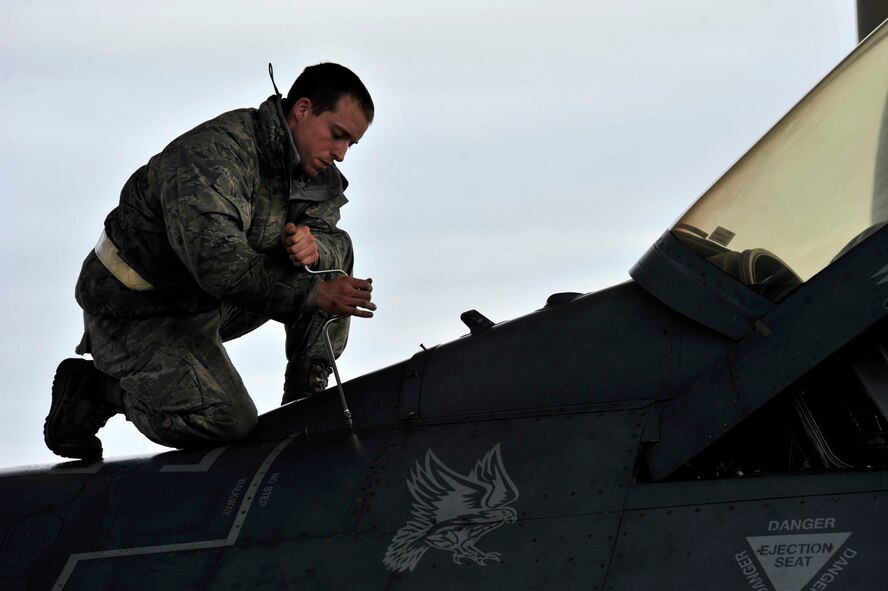 A U.S. Air Force Airman from Shaw Air Force Base, S.C., bolts a panel on to an F-16 Fighting Falcon, Nov. 21, 2013. An aircraft’s readiness is critical in maintaining mission capabilities. (U.S. Air Force photo by Airman 1st Class Jensen Stidham/Released)