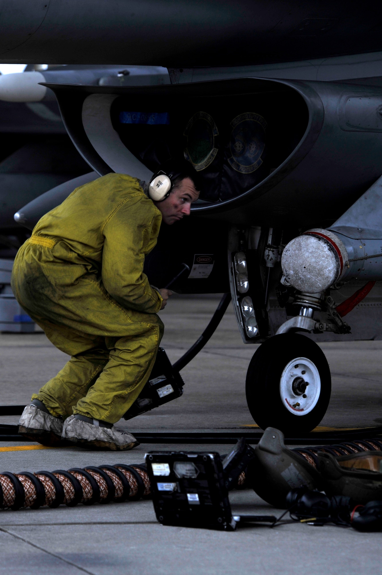 A U.S. Air Force Airman from Shaw Air Force Base, S.C., prepares an F-16 Fighting Falcon for flight, Nov. 21, 2013. All aircraft must be prepped and inspected before take-off to ensure the safety of the pilots. (U.S. Air Force photo by Airman 1st Class Jensen Stidham/Released)