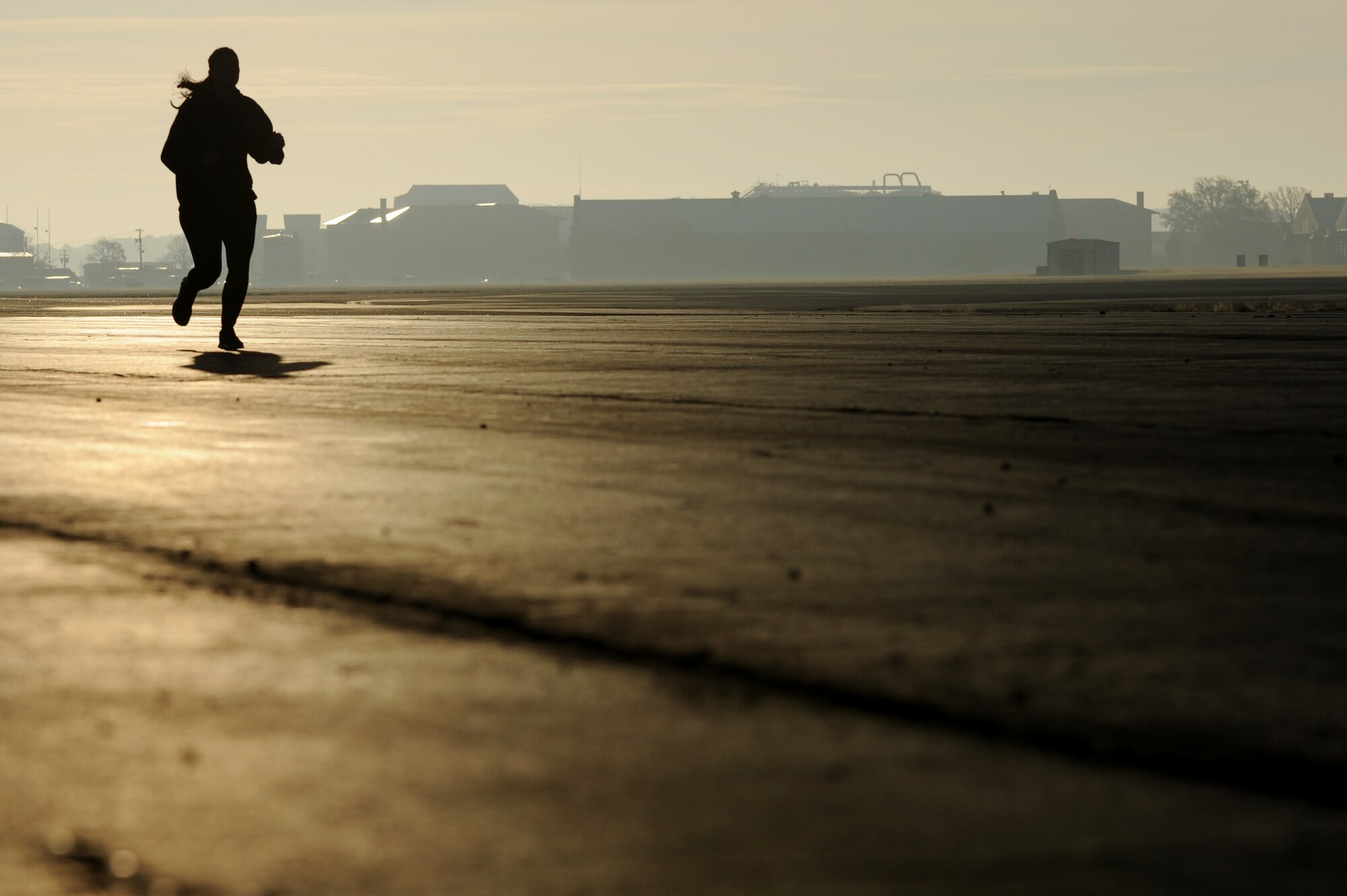 A runner treks across the flightline during the “Gobble Wobble” 5K race at Langley Air Force Base, Va., Nov. 22, 2013. Participants were encouraged to bring a donation of either food or money to the race in support of Operation Warmheart, which helps military families in need during the holiday season. (U.S. Air Force photo by Staff Sgt. Jarad A. Denton/Released)