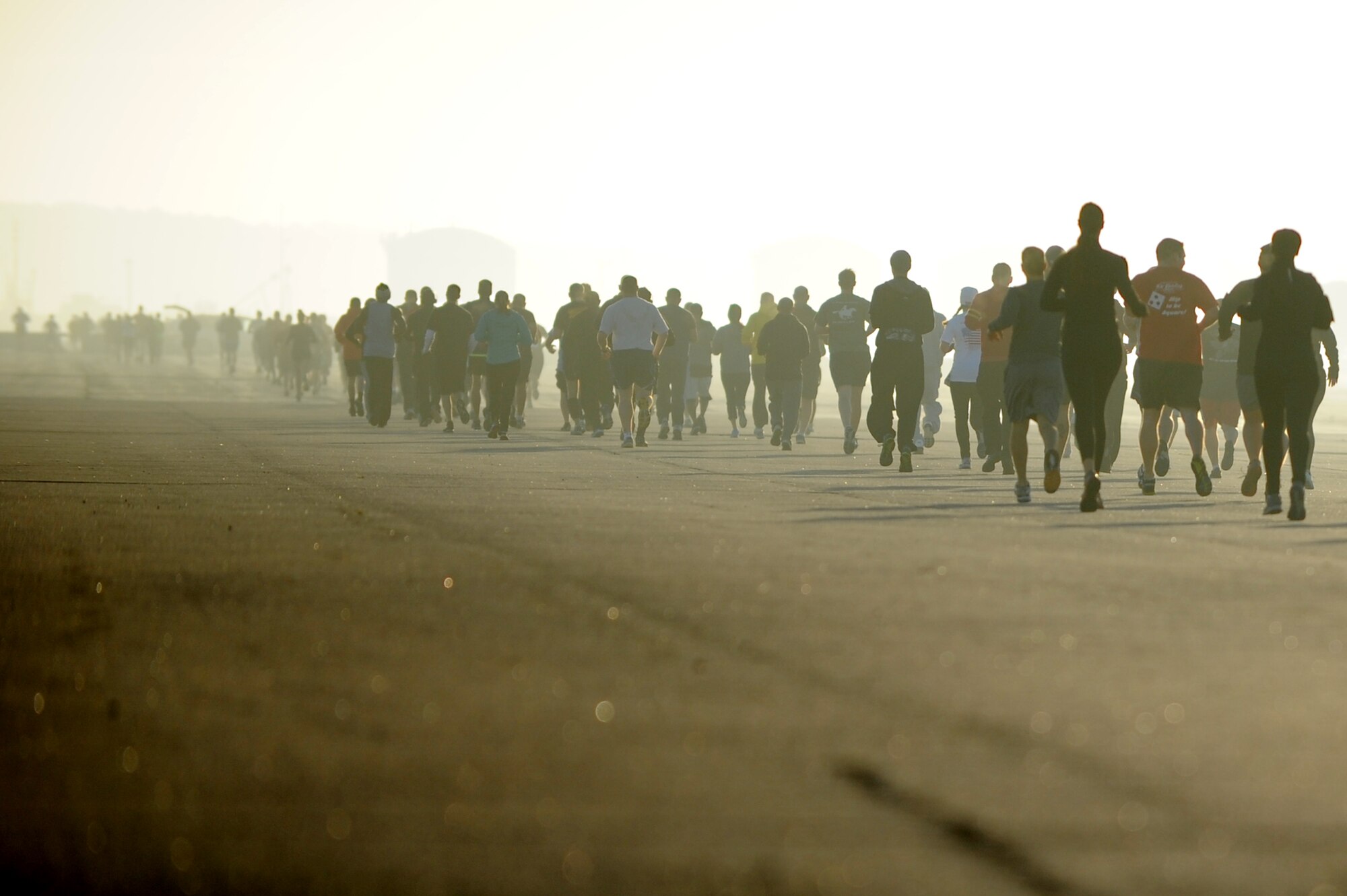 Runners trek across the flightline during the “Gobble Wobble” 5K race at Langley Air Force Base, Va., Nov. 22, 2013. The race was held by the Langley First Sergeants Council to collect donations for Operation Warmheart, which supports military families in need during the holiday season. (U.S. Air Force photo by Staff Sgt. Jarad A. Denton/Released)