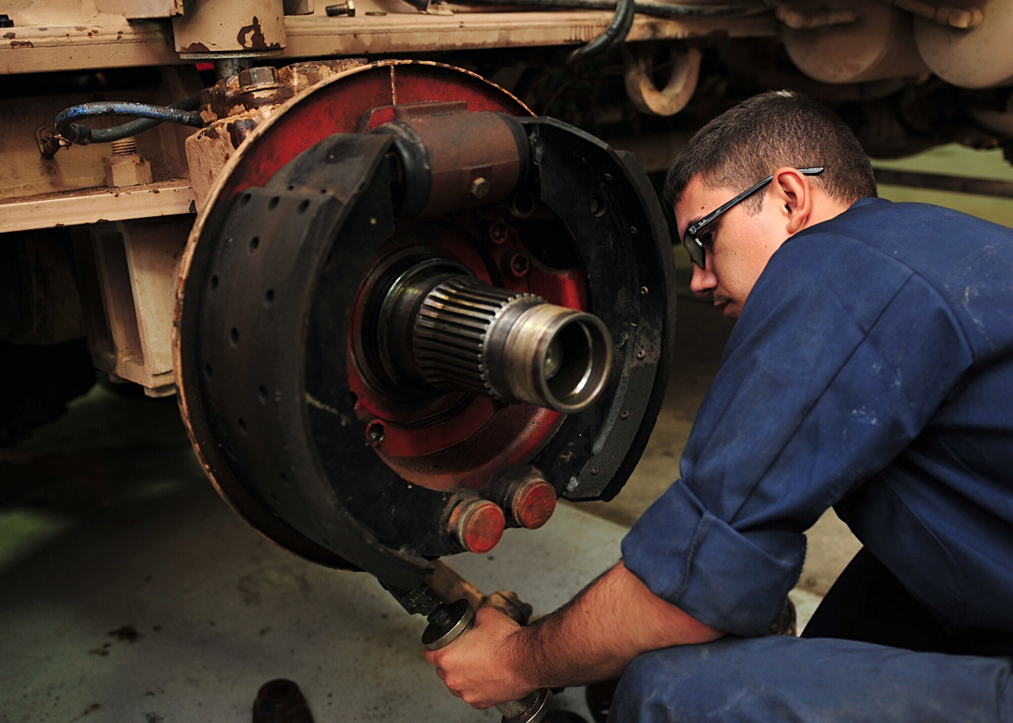 U.S. Air Force Senior Airman Clifford Lunsford, 380th Expeditionary Logistics Readiness Squadron vehicle maintenance technician, rebuilds an axle on a crane at an undisclosed location in Southwest Asia, Nov. 21, 2013. Vehicle technicians maintain a variety of vehicles, including fire trucks, aircraft re-fuelers, forklifts, cargo loaders, and other general and special purpose vehicles. Lunsford is deployed from Moody Air Force Base, Ga. (U.S. Air Force photo by Staff Sgt. Michael Means/Released)