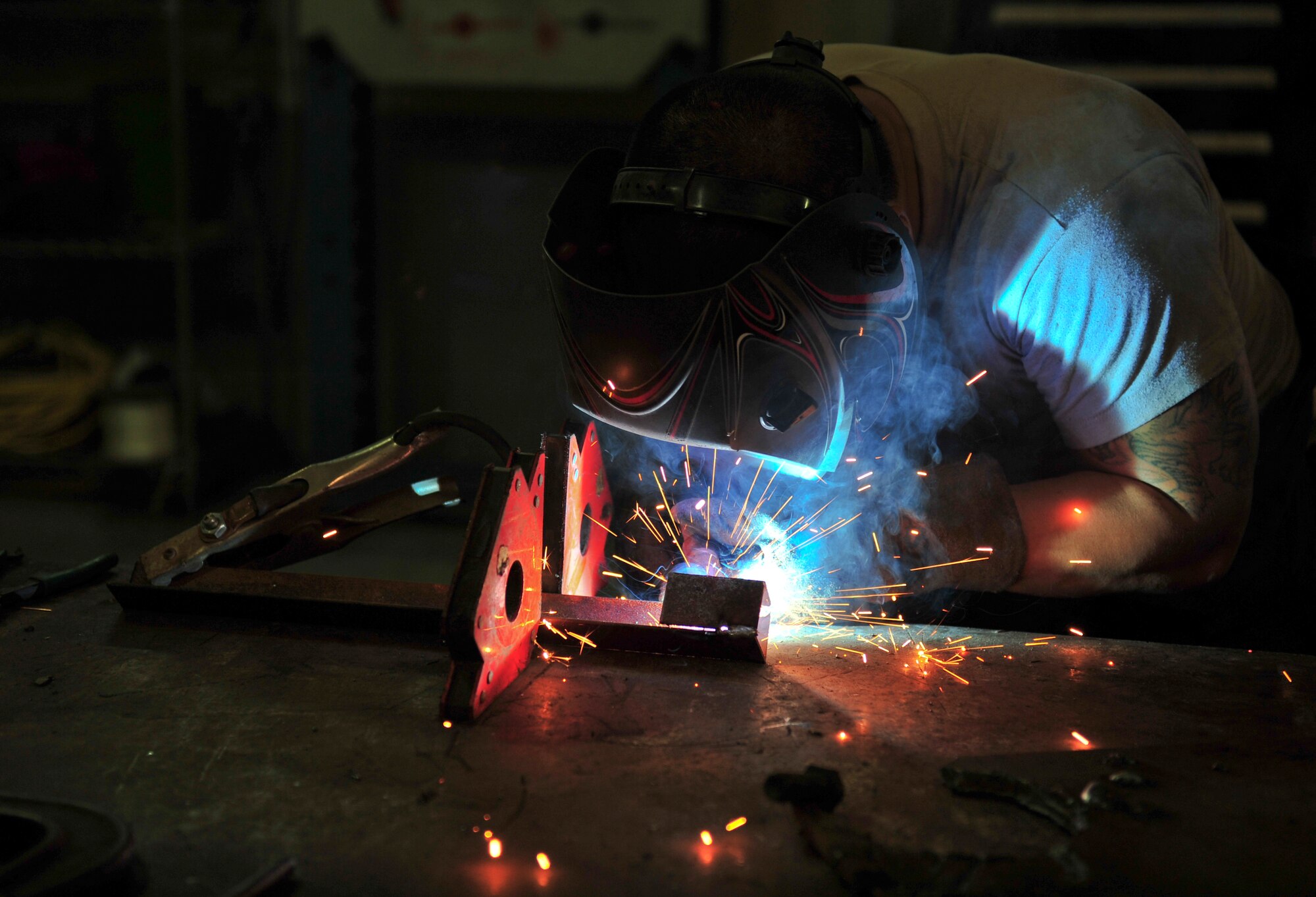 U.S. Air Force Senior Airman Hyung Kil, 380th Expeditionary Logistics Readiness Squadron vehicle maintenance technician, welds a maintenance stand in the vehicle maintenance facility at an undisclosed location in Southwest Asia, Nov. 21, 2013. Vehicle technicians are also required to know welding, grinding, hydraulics, electrical systems, diagnostics and emissions. Kil is deployed from Mountain Home Air Force Base, Idaho. (U.S. Air Force photo by Staff Sgt. Michael Means/Released)