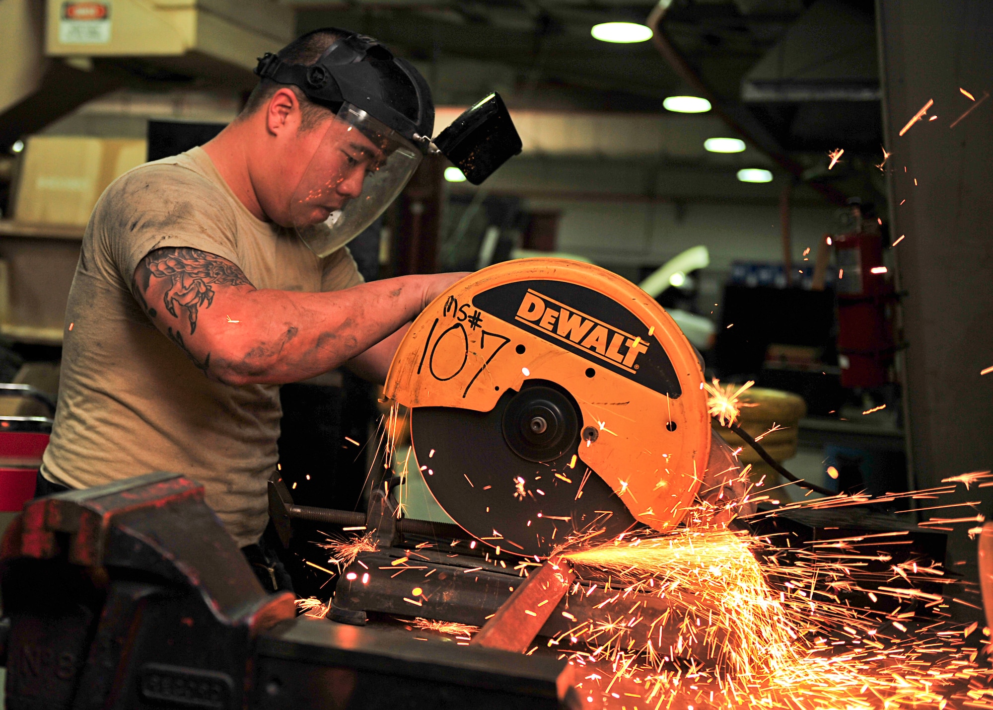 U.S. Air Force Senior Airman Hyung Kil, 380th Expeditionary Logistics Readiness Squadron vehicle maintenance technician, cuts a metal bracket in the vehicle maintenance facility at an undisclosed location in Southwest Asia, Nov. 21, 2013. Vehicle maintenance does their own inspections, diagnostics and repairs of every kind. Kil is deployed from Mountain Home Air Force Base, Idaho. (U.S. Air Force photo by Staff Sgt. Michael Means/Released)