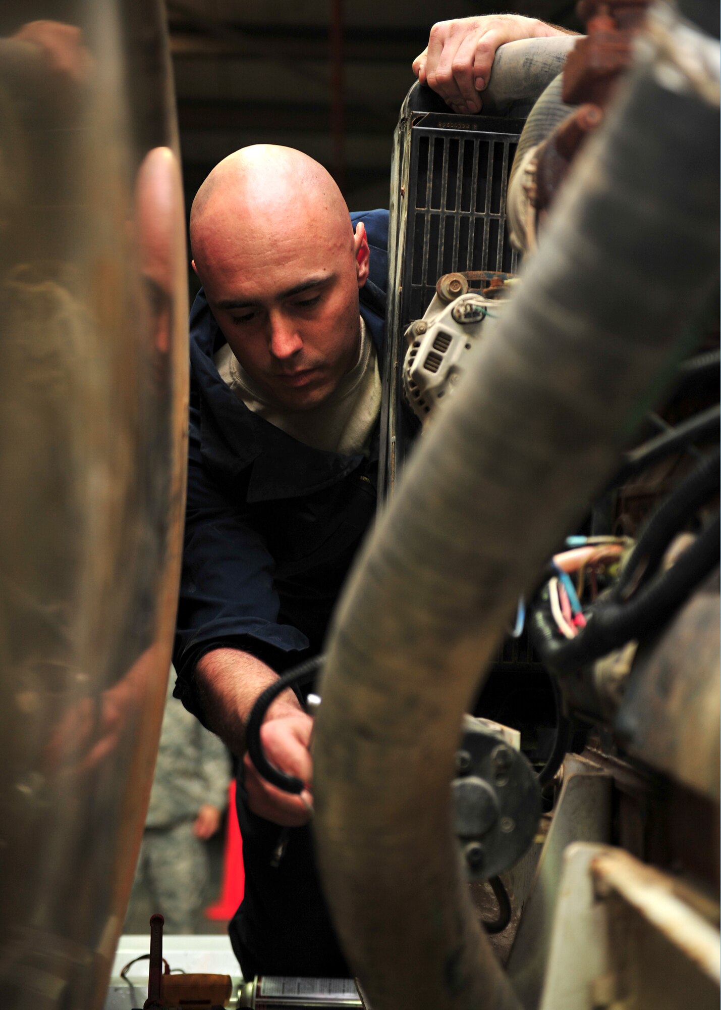 U.S. Air Force Staff Sgt. Michael Messinger, 380th Expeditionary Logistics Readiness Squadron vehicle maintenance technician, troubleshoots a priming pump on a water truck at an undisclosed location in Southwest Asia, Nov. 21, 2013. The vehicle maintenance flight is responsible for managing and maintaining more than 800 vehicles and equipment. Messinger is deployed from Shaw Air Force Base, S.C. (U.S. Air Force photo by Staff Sgt. Michael Means/Released)  