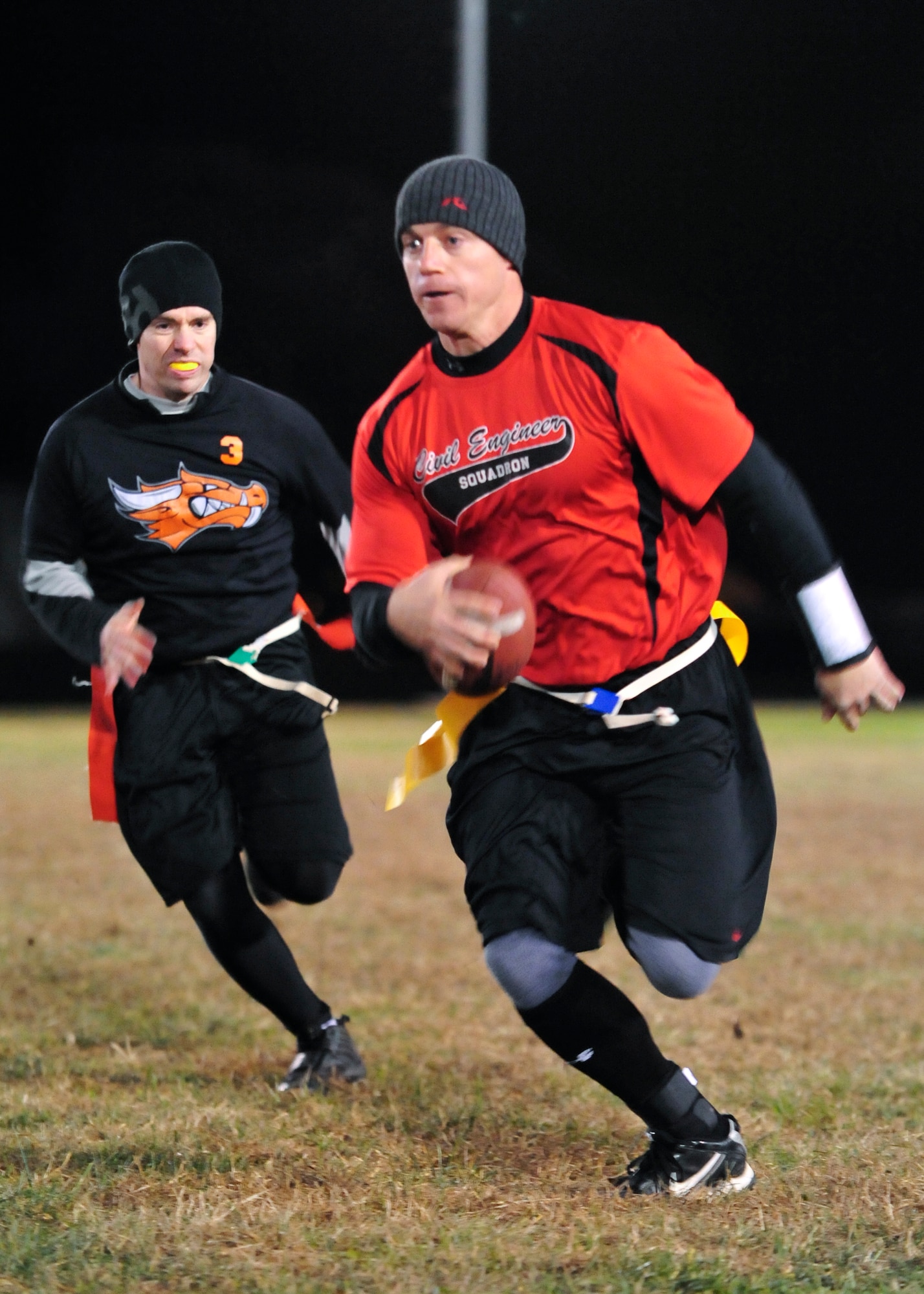 Steven Peaper, 436th Civil Engineer Squadron quarterback, runs toward the end zone during a flag football game Nov. 20, 1013, at Dover Air Force Base, Del. Peaper helped lead the 436th CES 26-7 crushing of the 436th Operations Support Squadron. (U.S. Air Force photo/Airman 1st Class William Johnson)