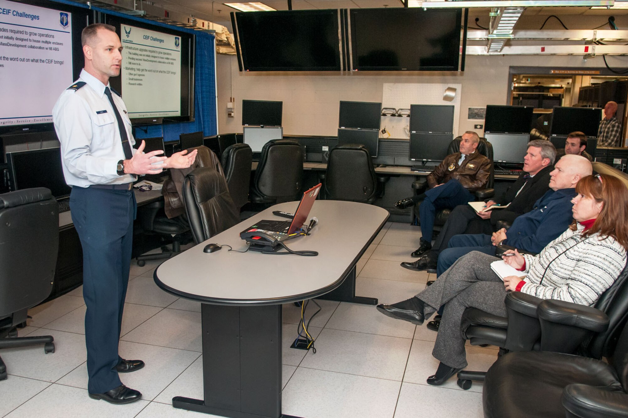 HANSCOM AIR FORCE BASE, Mass. -- Maj. Chris Dupin, director of the C4ISR Enterprise Integration Facility, briefs Cathy Haverstock and Sean Conroy, both senior research analysts on the National Commission on the Structure of the Air Force, along with other guests including Maj Gen. L. Scott Rice, Mass. adjutant general (seated in between), during their visit here Nov. 21.  The commission staff members also visited the Mass. National Guard Joint Force Headquarters here, MIT Lincoln Laboratory, MITRE and the Harvard University Homeland Security Institute. (U.S. Air Force photo by Rick Berry)