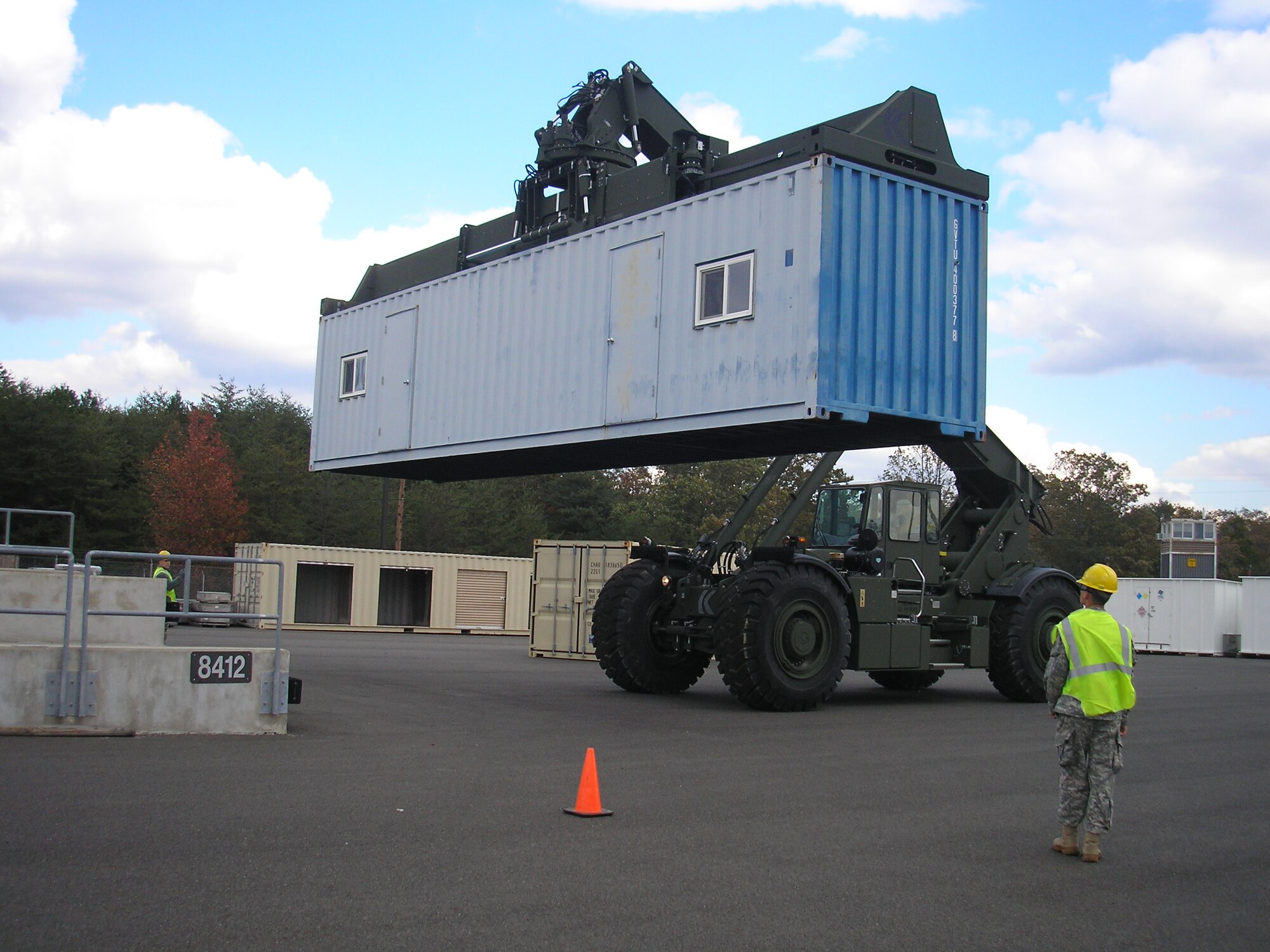 Soldiers of the 1011th Quartermaster Company practice lifting and moving containers during Rough Terrain Container Handler and forklift operator refresher training Oct. 24, 2013, at Joint Base McGuire-Dix-Lakehurst, N.J. (U.S. Air Force courtesy photo/Released)
