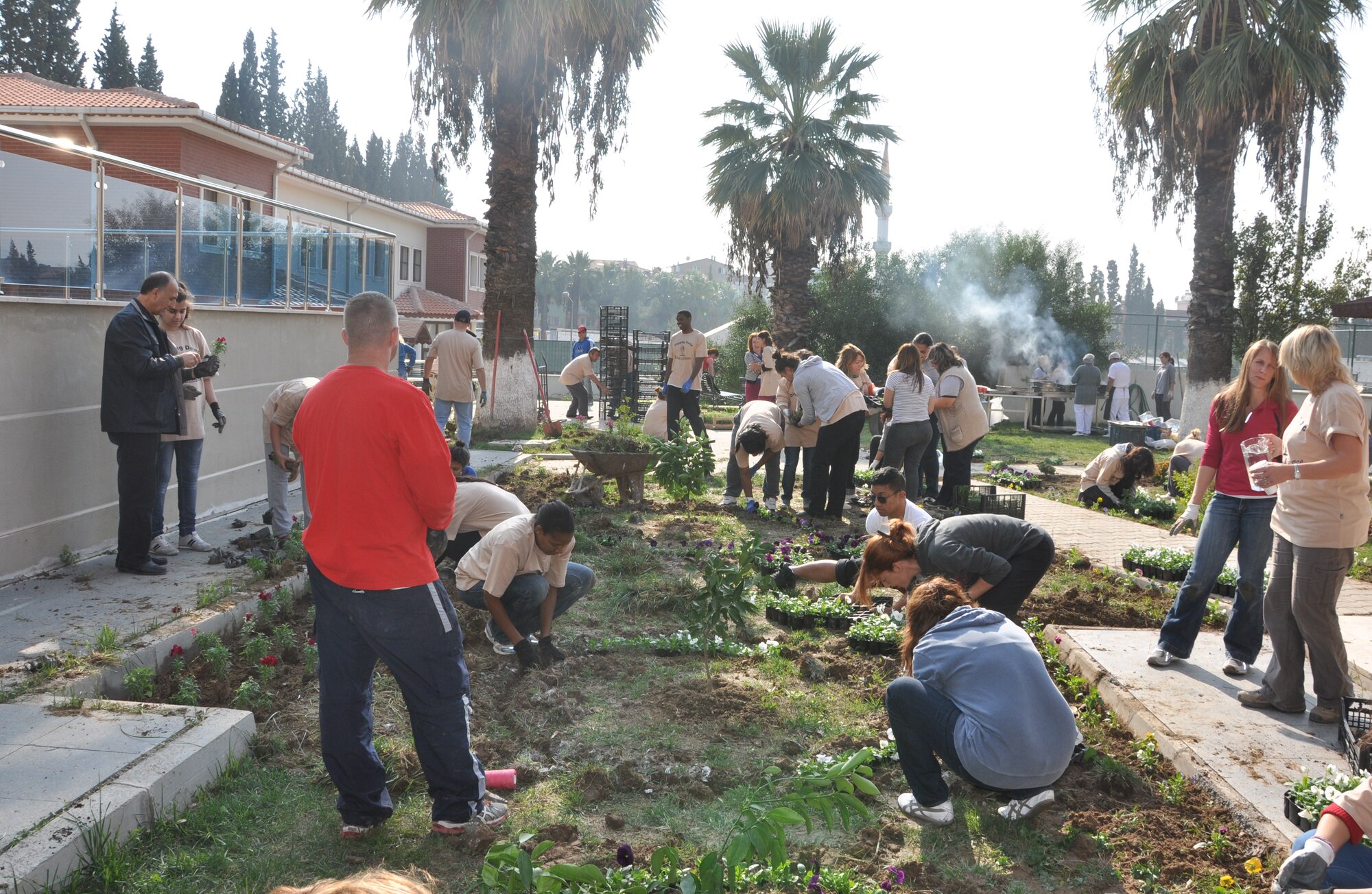 NATO and 425th Air Base Squadron members plant flowers and trees at a local girls’ 
care and rehabilitation center garden as part of a landscaping project Nov. 16. (Courtesy photo by Tanju Varlikli)