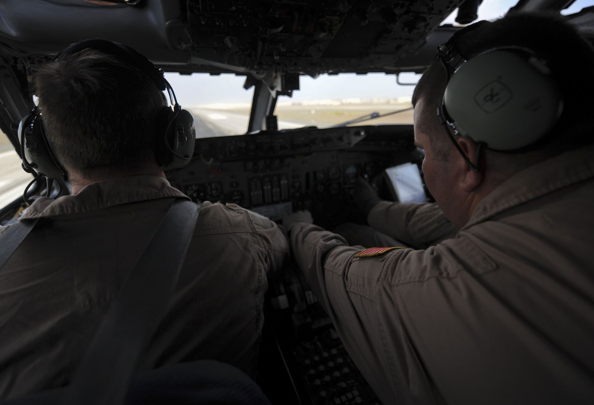 U.S. Air Force Staff Sgt. Gatlin Rowland, right, 968th Expeditionary Airborne Air Control Squadron E-3 Sentry flight engineer, and U.S. Air Force Capt. Aaron Shanor, 968 EAACS E-3 aircraft commander, push the throttle forward on take-off at an undisclosed location in Southwest Asia Nov. 16, 2013. Take-off and landing are a team effort between aircraft commander, co-pilot, and flight engineer, each position is responsible for checking various indicators such as power, pressure and rpms. (U.S. Air Force photo by Staff Sgt. Jacob Morgan)