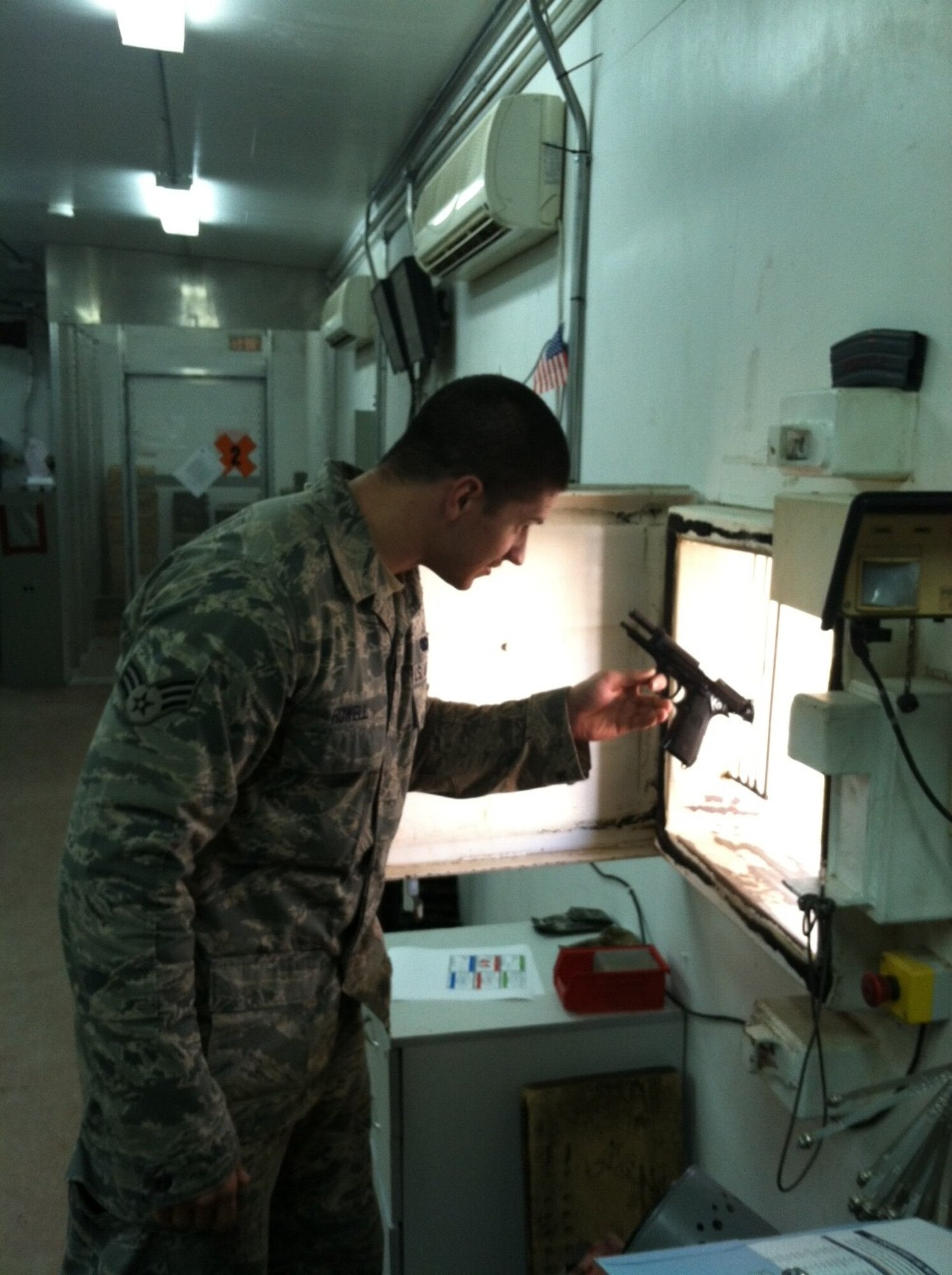 Senior Airman Joseph Howell issues weapons to other security forces members at the 387th Expeditionary Security Forces Squadron, undisclosed location, Southwest Asia.  Howell comes from a military family and credits that for his decision to pursue a military career.  He is on his first deployment and handles the task of ensuring his base is safe and secure.  Howell, a native of Louisville, Ky., is deployed from the 123rd Airlift Wing, Kentucky Air National Guard.  (Courtesy photo)