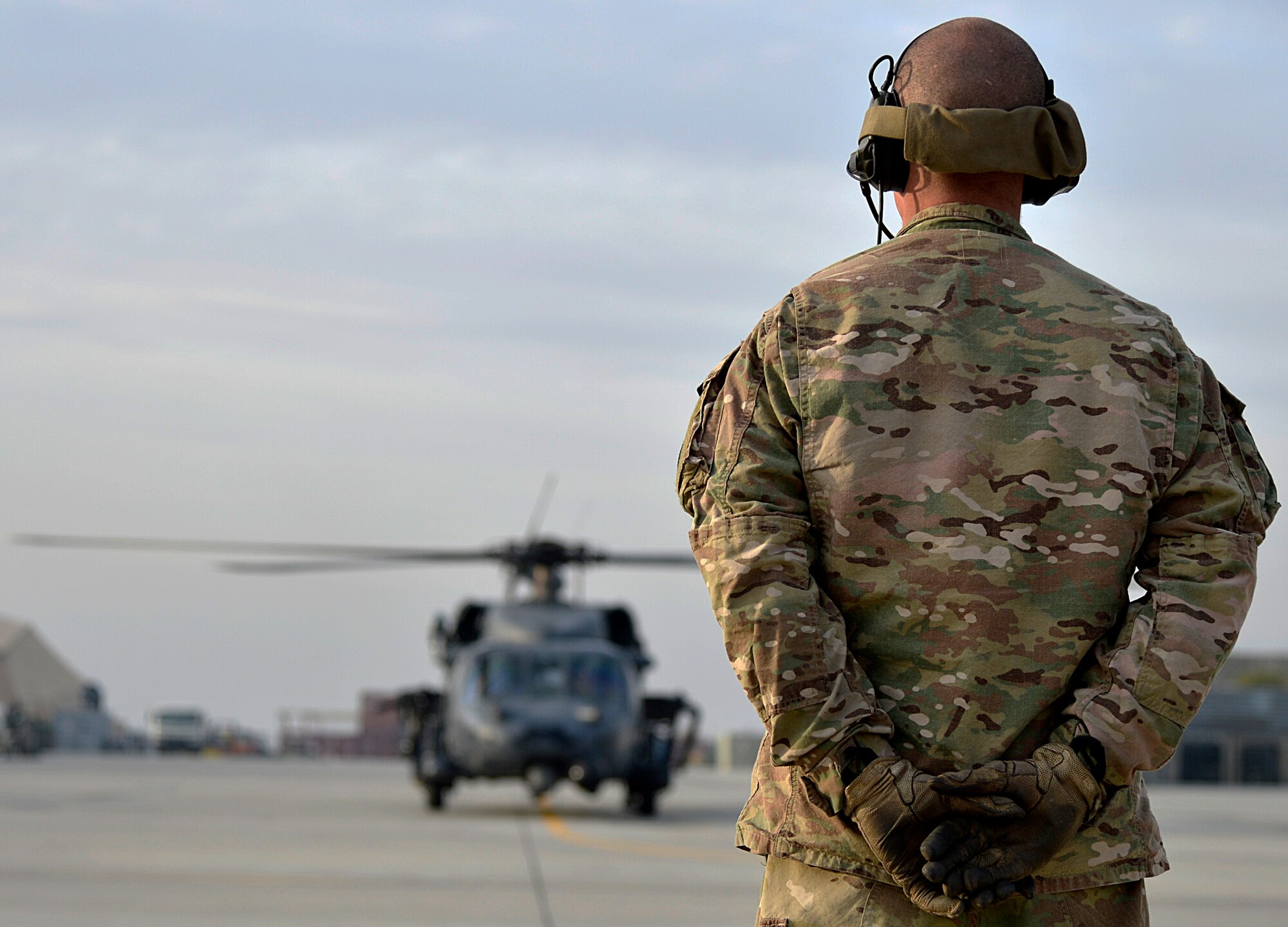 U.S. Air Force Airman 1st Class Josh Lombardo, 83rd Expeditionary Rescue Squadron crew chief, prepares to marshall a HH-60G Pave Hawk at Bagram Airfield, Afghanistan Nov. 22, 2013. The 83rd ERQS utilizes the Pave Hawk to accomplish their assault, secure and dominate rescue objectives. (U.S. Air Force photo by Senior Airman Kayla Newman/Released)