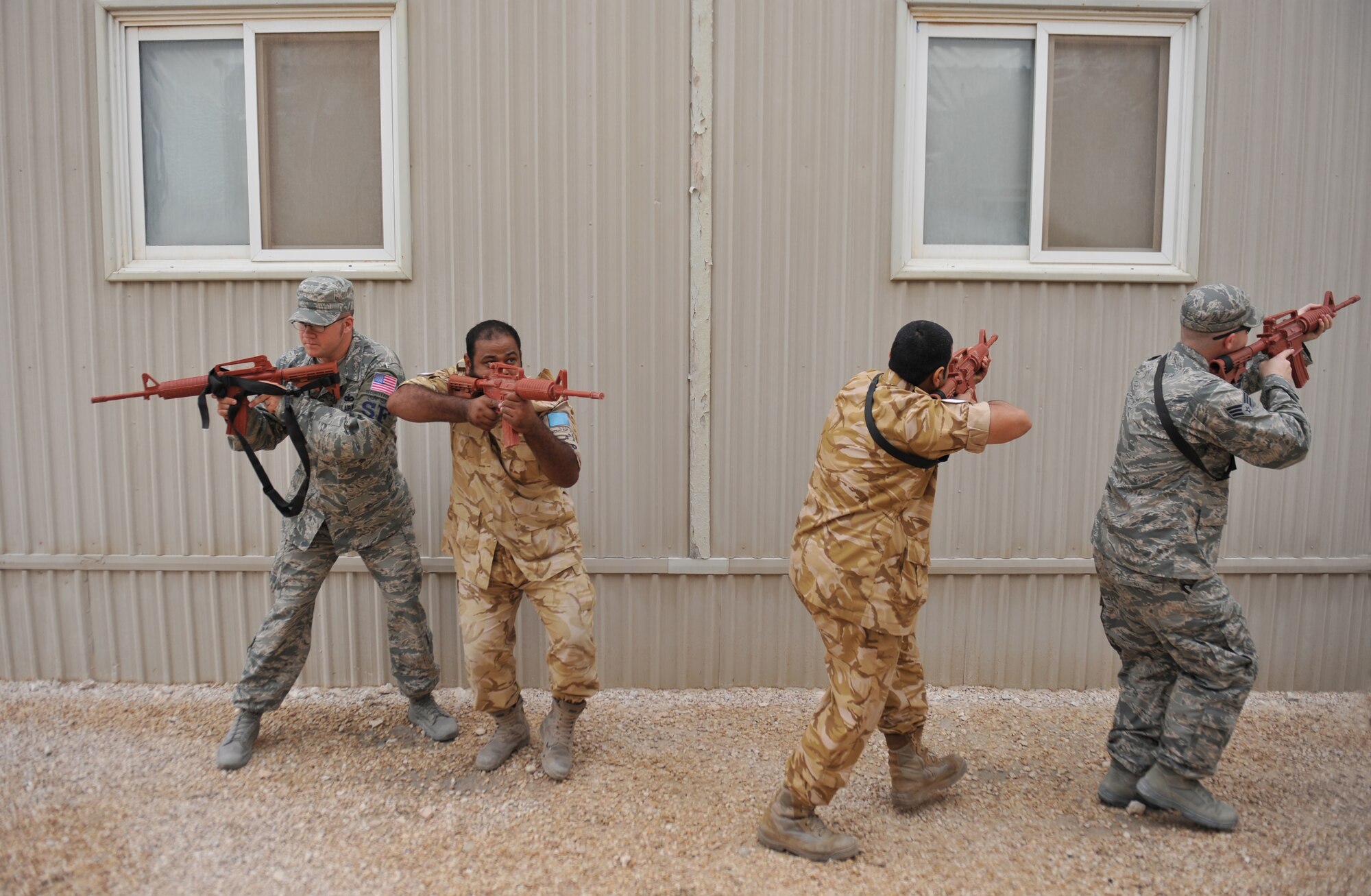 Members of the 379th Expeditionary Security Forces Squadron and host nation military members perform tactical movements at the 379th Air Expeditionary Wing in Southwest Asia, Nov. 20, 2013. The 379th ESFS held cooperative mentorship with their counterparts to enhance bonds and learn different security techniques and procedures that are inherent to each service. (U.S. Air Force photo/Master Sgt. David Miller)