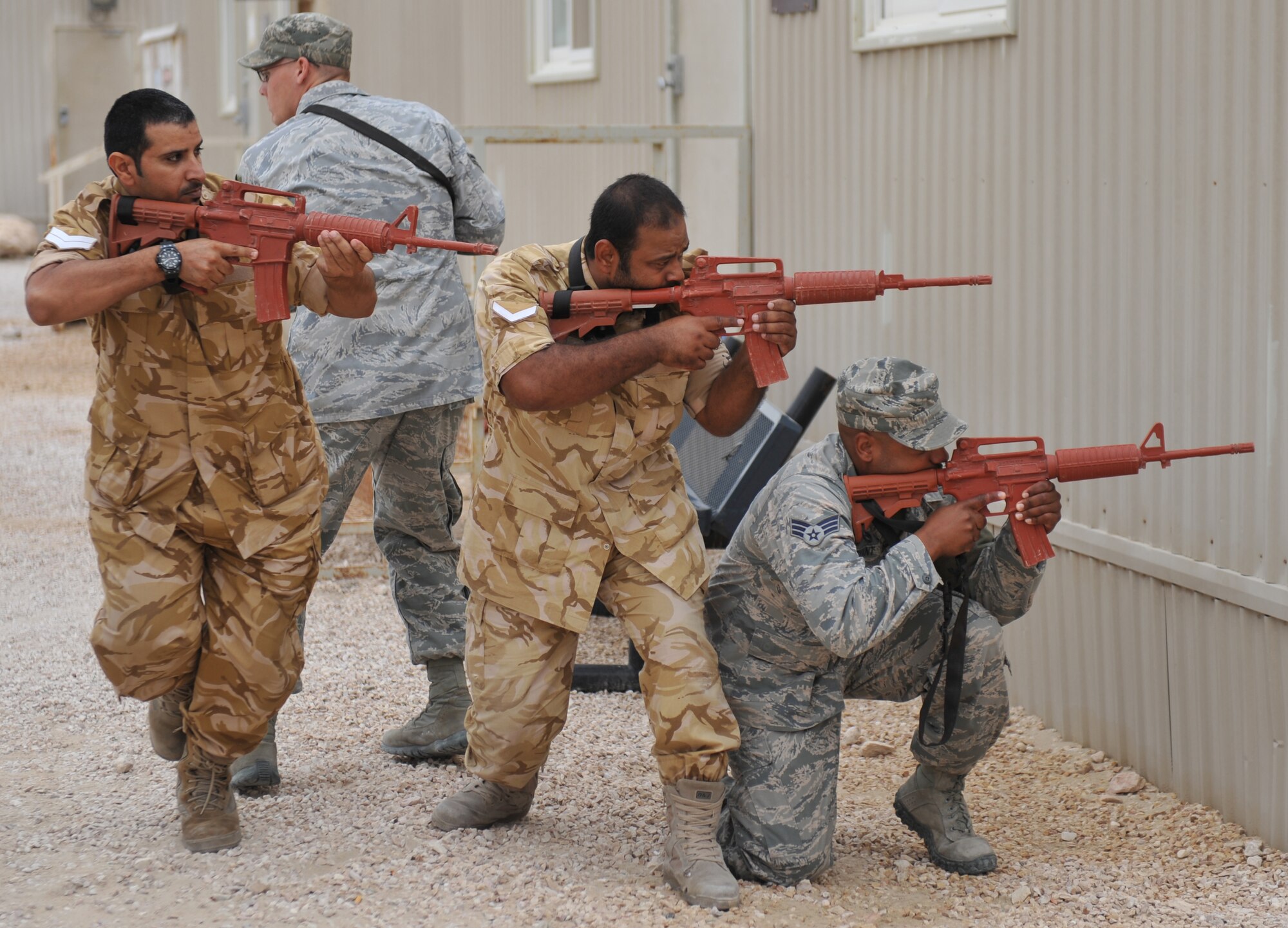 Members of the 379th Expeditionary Security Forces Squadron and host nation military members practice danger crossing techniques at the 379th Air Expeditionary Wing in Southwest Asia, Nov. 20, 2013. The 379th ESFS held mentotship seesions with their counterparts to enhance bonds and teach different security techniques so there is seamless integration. (U.S. Air Force photo/Master Sgt. David Miller)