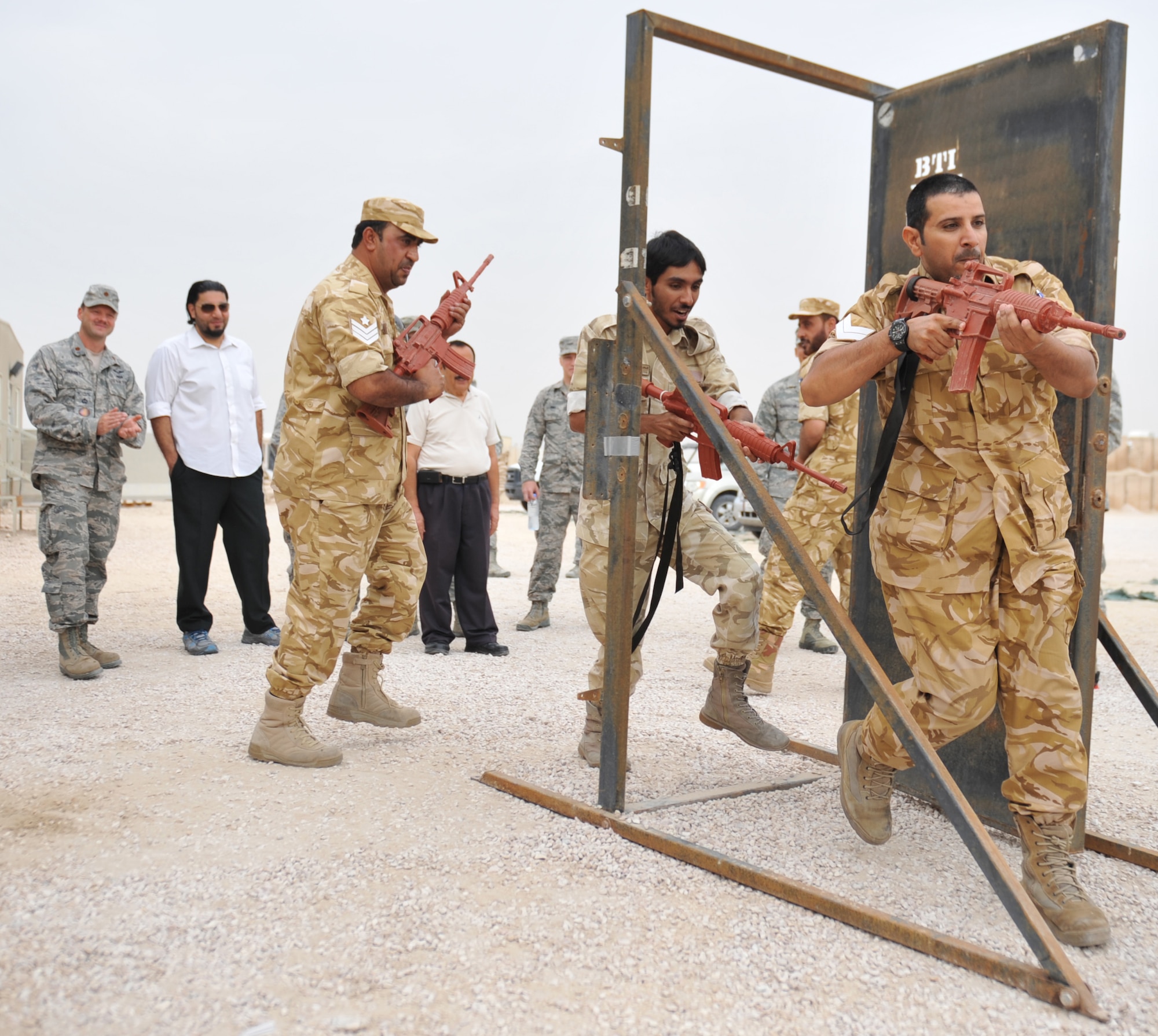 Host nation military members practice building entry exercises with the 379th Expeditionary Security Forces Squadron at the 379th Air Expeditionary Wing in Southwest Asia, Nov. 20, 2013. The 379th ESFS held cooperative mentorship sessions with their counterparts to enhance working relationships and learn different security techniques that are inherent to each service. (U.S. Air Force photo/Master Sgt. David Miller)