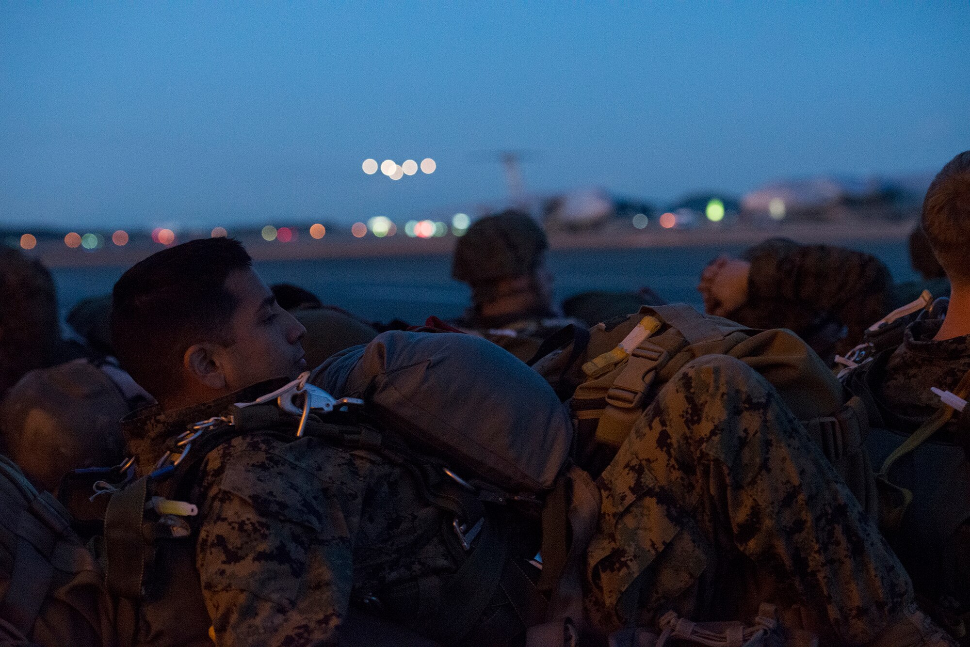 Marines with the 3rd Reconnaissance Battalion, 3rd Marine Division, 3rd Marine Expeditionary Force, wait to board a C-130 Hercules at Yokota Air Base, Japan, Nov. 21, 2013. The Marines were at Yokota for their last jump of 2013 to ensure their members maintained jump currency and readiness. (U.S. Air Force by Senior Airman Cody H. Ramirez)