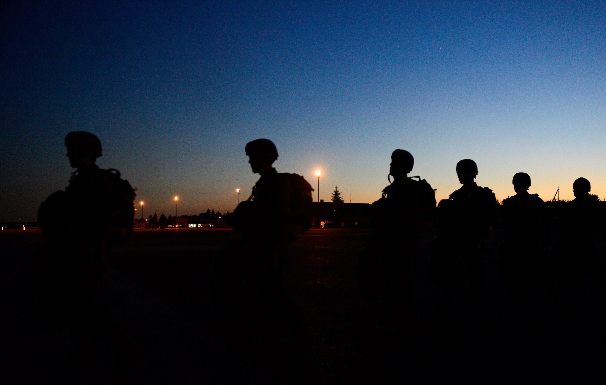 Marines with the 3rd Reconnaissance Battalion, 3rd Marine Division, 3rd Marine Expeditionary Force, head toward a C-130 Hercules before a night jump at Yokota Air Base, Japan, Nov. 21, 2013. The Marines are required to jump at least four times a year to maintain jump qualifications. (U.S. Air Force photo by Senior Airman Cody H. Ramirez)