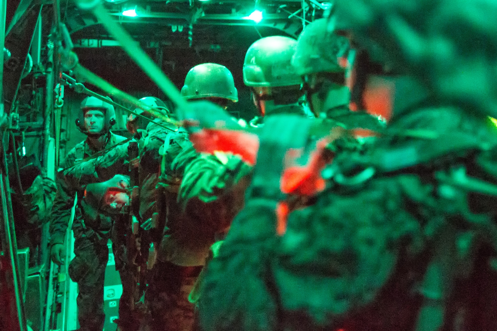 Marines with the 3rd Reconnaissance Battalion, 3rd Marine Division, III Marine Expeditionary Force, prepare to jump out of a C-130 Hercules over Yokota Air Base, Japan, Nov. 21, 2013. The training not only allowed the marines to practice jumping, but it also allowed the Yokota aircrews to practice flight tactics and timed-package drops. (U.S. Air Force photo by Osakabe Yasuo/Released)