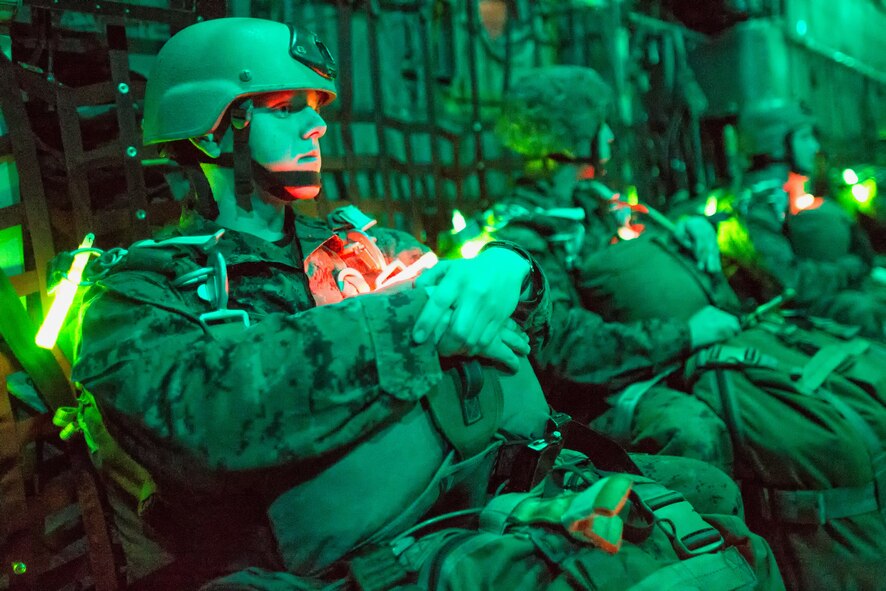Marines with the 3rd Reconnaissance Battalion, 3rd Marine Division, III Marine Expeditionary Force, wait on a C-130 Hercules prior to taking part in night jump training over Yokota Air Base, Japan, Nov. 21, 2013. The training not only allowed the marines to practice jumping, but it also allowed the Yokota aircrews to practice flight tactics and timed-package drops. (U.S. Air Force photo by Osakabe Yasuo/Released)