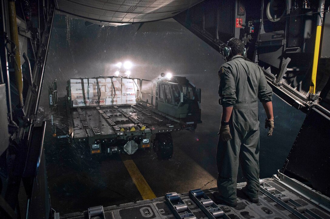 U.S. Air Force Staff Sgt. Mike Jones directs a forklift of supplies off an MC-130 Combat Talon II aircraft from the U.S. Agency for International Development during Operation Damayan, Tacloban, Philippines, Nov. 20, 2013. Jones is assigned to the 1st Special Operation Squadron. U.S. military forces are assisting the Philippine government's relief efforts in the aftermath Typhoon Haiyan.