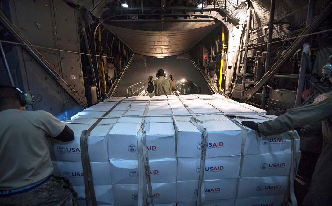 U.S. Air Force Staff Sgt. Mike Jones, center, directs a forklift of supplies onto an MC-130 Combat Talon II aircraft from the U.S. Agency for International Development during Operation Damayan in Manila, Philippines, Nov. 20, 2013. Jones is assigned to the 1st Special Operation Squadron.