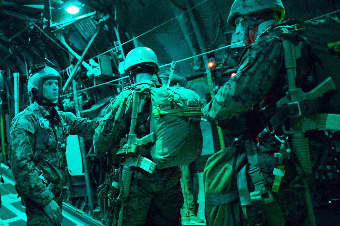 U.S. Marines prepare to jump out of a C-130 Hercules as part of night jump training over Yokota Air Base, Japan, Nov. 21, 2013. 