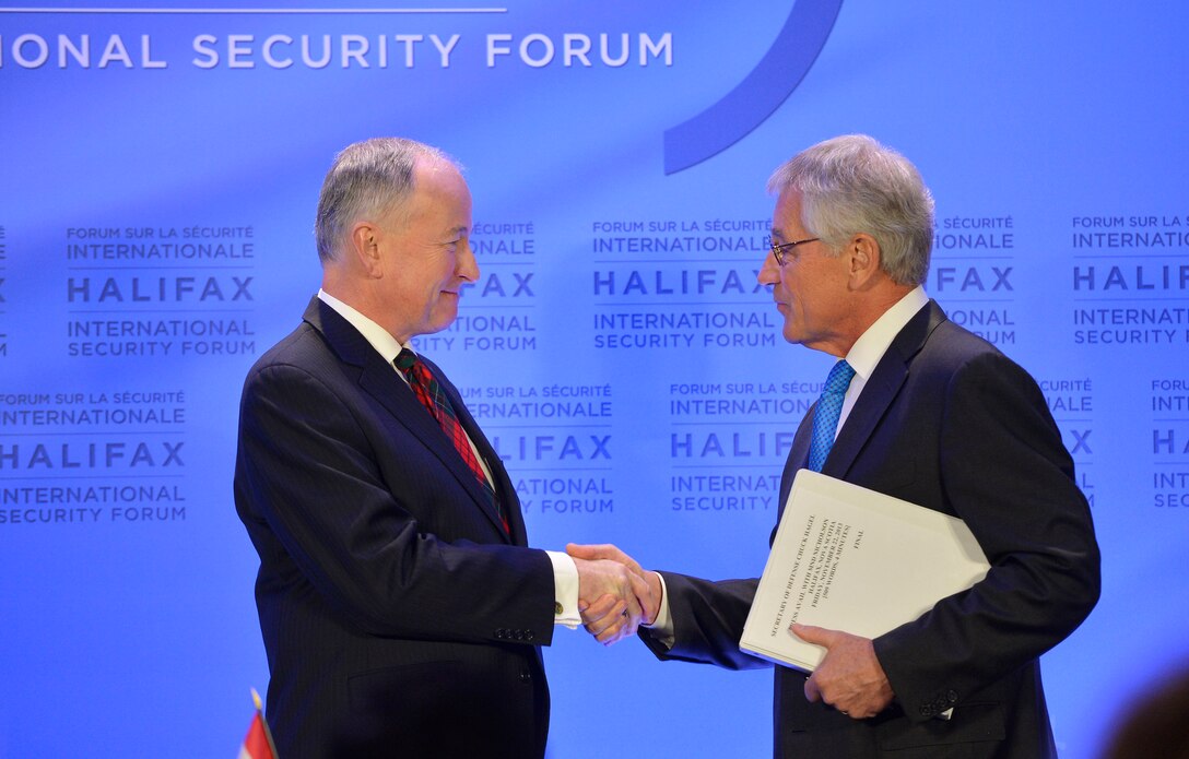 U.S. Defense Secretary Chuck Hagel, right, and Canadian Defense Minister Rob Nicholson shake hands after a press conference where they signed a memorandum of understanding at the Halifax International Security Forum in Halifax, Nova Scotia, Nov. 22, 2013.