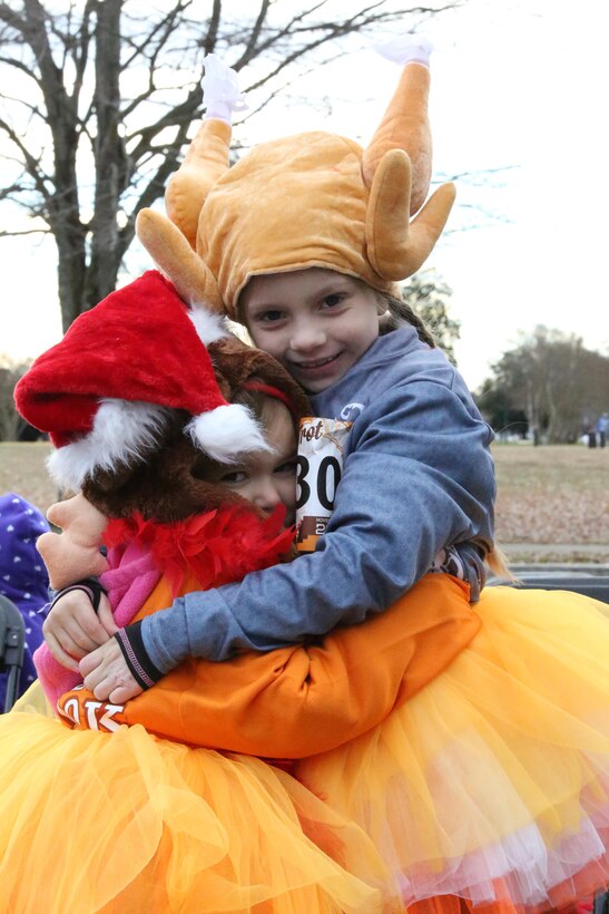 Two runners give each other a hug after the Turkey Trot Mile aboard Marine Corps Base Quantico on Nov. 23, 2013. More than 300 people participated in the run. 
