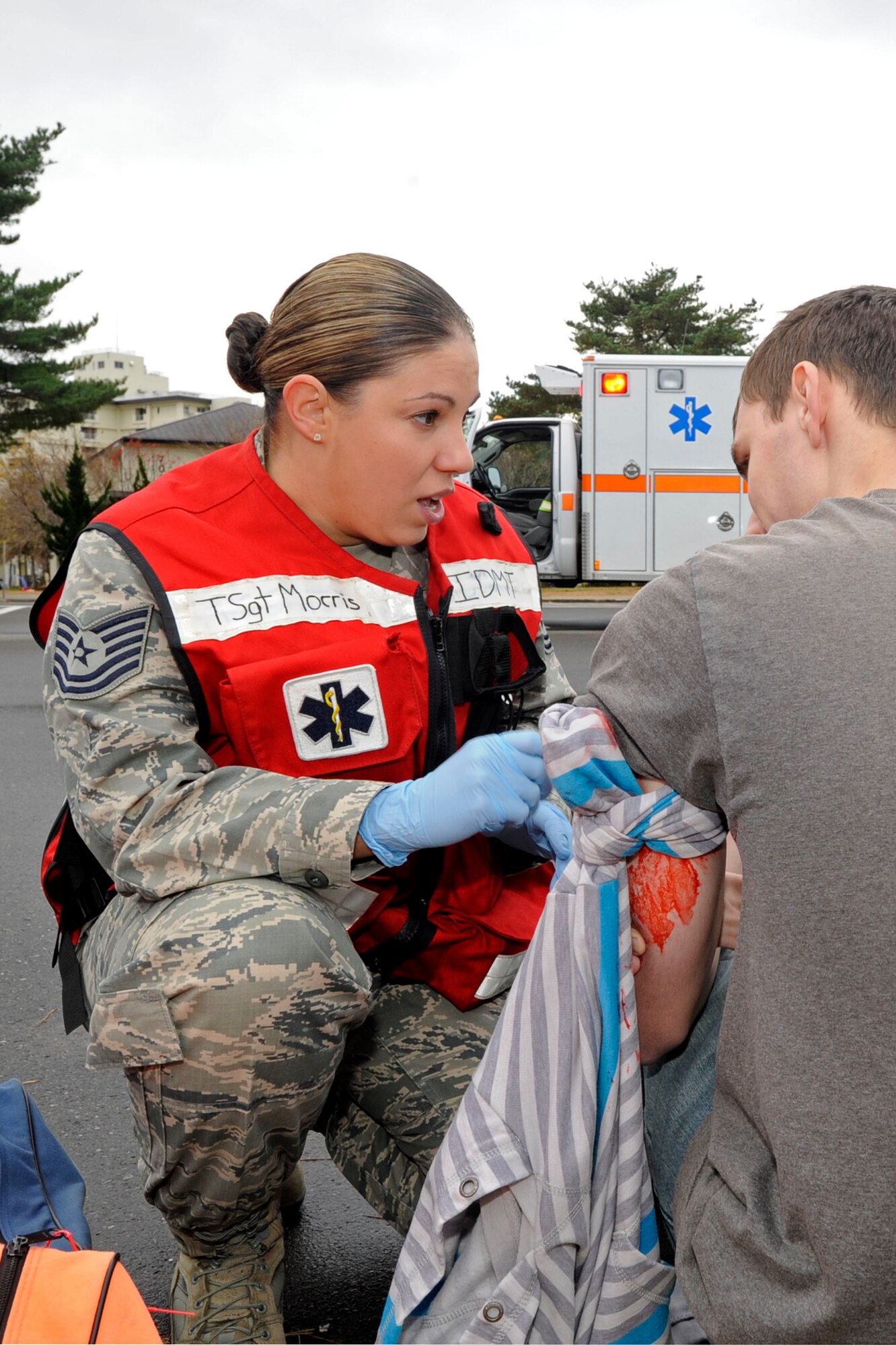 MISAWA AIR BASE, Japan -- Tech. Sgt. Christina Morris, 13th Fighter Squadron Flight Medicine provides first aid to a simulated victim, during an Active Shooter Emergency Management Exercise, at Edgren High School, Nov. 20, 2013. Medical professionals were tested on their life saving responses and ability to provide aid during a crisis like an active shooter incident. (U.S. Air Force photo by Staff Sgt. Tong Duong/ Released)