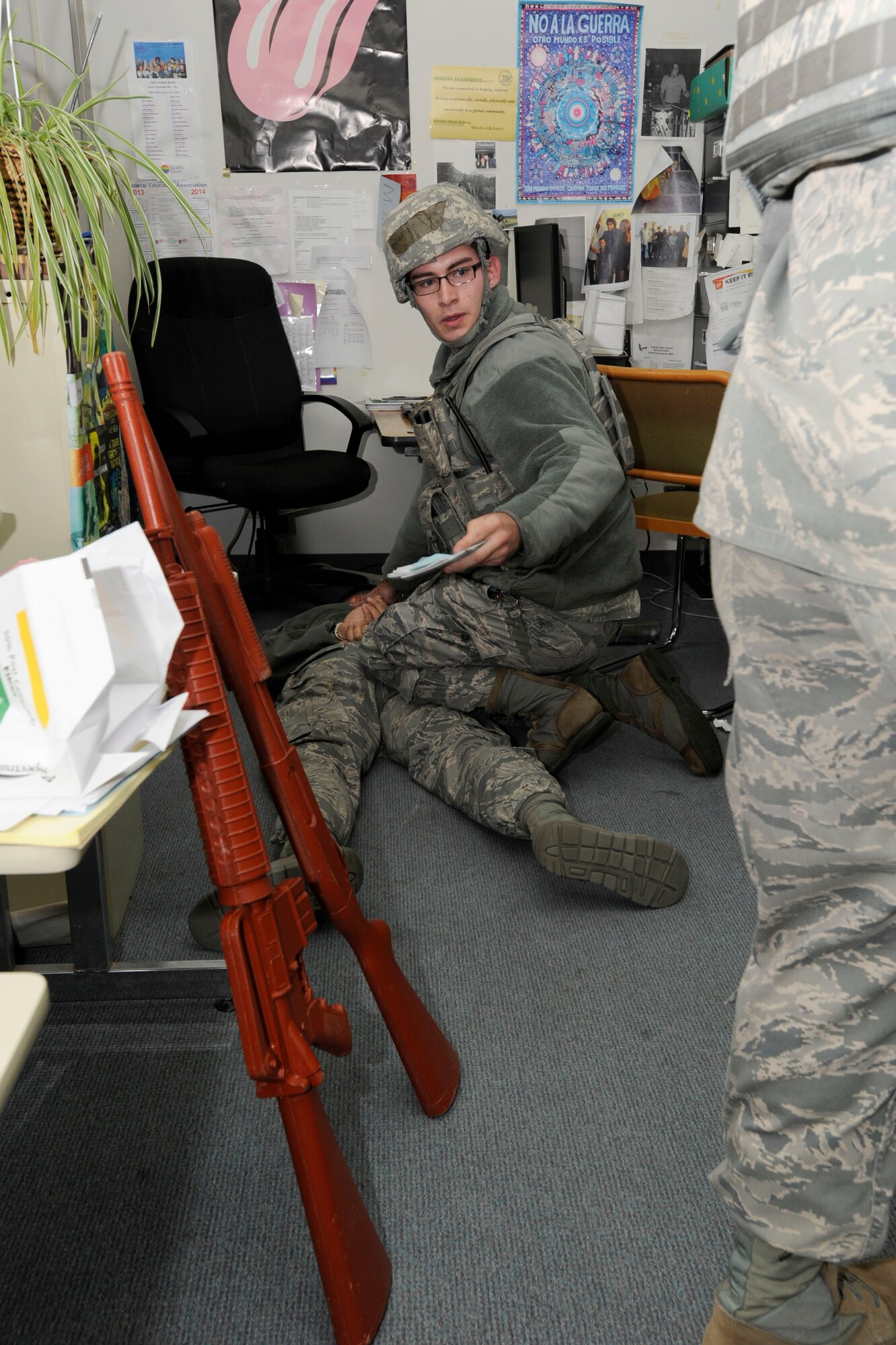 MISAWA AIR BASE, Japan -- Airman 1st Class Matthew White, 35th Security Forces Squadron defender detains a simulated active shooter suspect, while Senior Airman Joseph Guy provides backup, during an Active Shooter Emergency Management Exercise, at Edgren High School, Nov. 20, 2013. Defenders train for scenarios such as these to preserve life. (U.S. Air Force photo by Staff Sgt. Tong Duong/ Released)