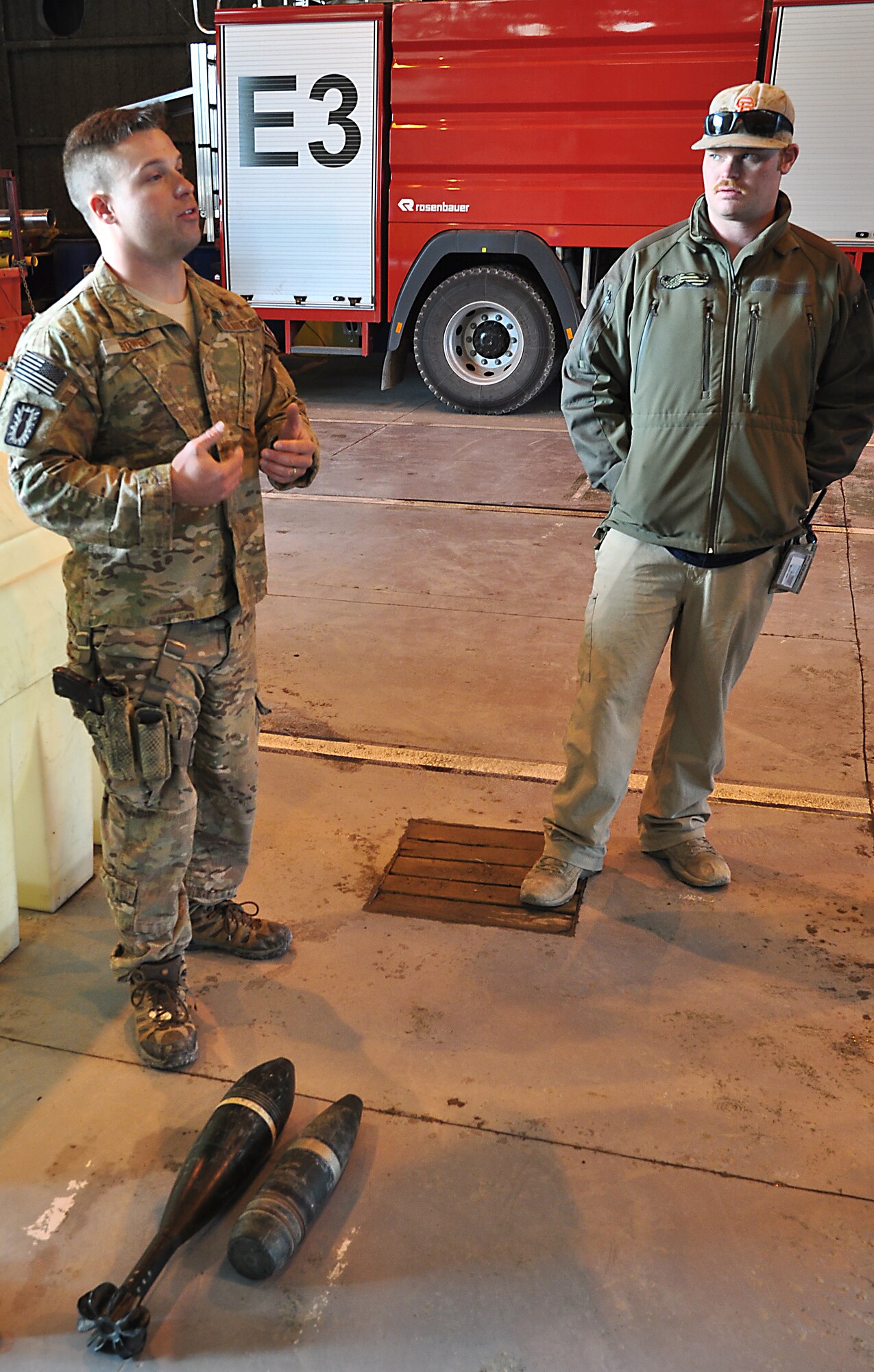 Staff Sgt. Christopher Bowen (left), 466th Explosive Ordnance Disposal Operating Location Bravo Flight, teaches Kandahar Airfield, Afghanistan, firefighters ways to identify and deal with potential unexploded ordnance Nov. 21, 2013, at the KAF Fire Department. Bowen is deployed from Dyess Air Force Base, Texas. (U.S. Air Force photo by Capt. Jason Smith)