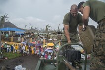 131123-N-JC374-172 - PALO, Republic of the Philippines (Nov. 23, 2013) - U.S. Marines assigned to Combat Logistics Battalion 4 (CLB 4) refuel a water pump during a water distribution operation on Palo, Nov. 23. CLB 4 is part of Joint Task Force 505 in support of Operation Damayan. (U.S. Navy photo by Mass Communication Specialist 3rd Class Jonah Z. Stepanik/Released)