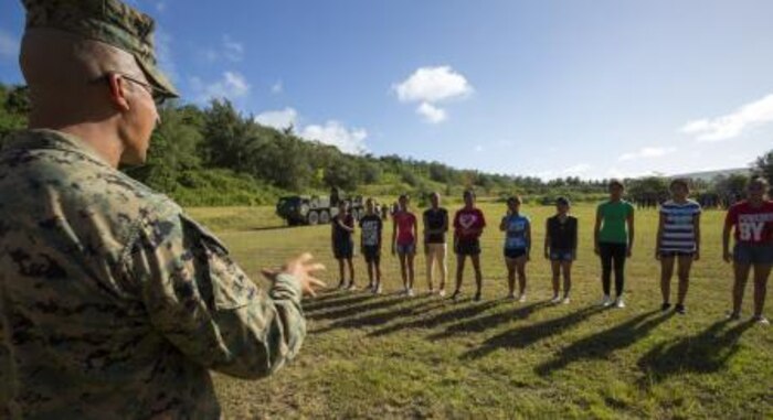 Staff Sgt. Jose R. Camberos from Los Angeles, Cali., teaches military troop movement to cadets to instill discipline Nov. 22 at the Tinian Junior Senior High School Junior Reserve Officers’ Training Corps field. Cadets from TJSHS JROTC partook in a field meet with Marines and sailors to build camaraderie between one another. Camberos is operations chief of heavy equipment with Marine Wing Support Squadron 171, Marine Aircraft Group 12, 1st Marine Aircraft Wing, III Marine Expeditionary Force.