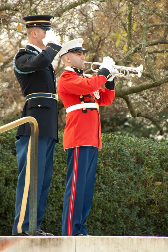 Master Sgt. John Abbracciamento sounds "Taps" at a wreath-laying ceremony at Arlington National Cemetery in honor of President John F. Kennedy on the 50th anniversary of his death. Nov. 22, 2013 (U.S. Marine Corps photo by Staff Sgt. Rachel Ghadiali/Released)