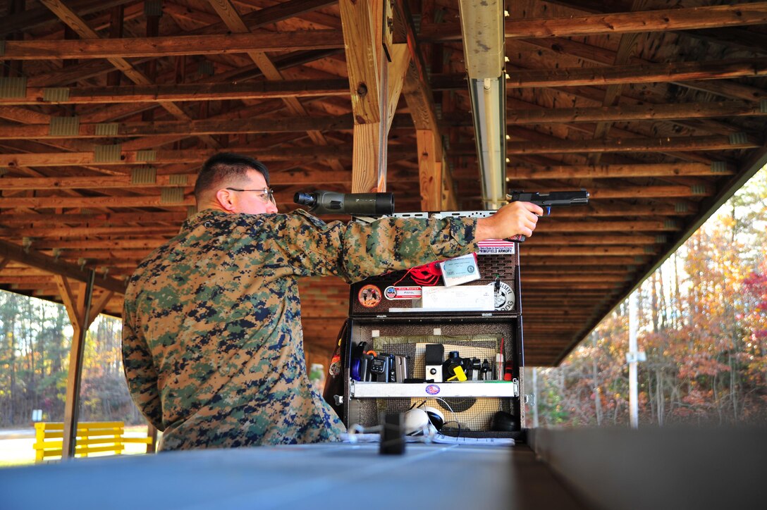 Staff Sgt. Jonathan Shue competitor/instructor, Marine Corps Shooting Team, dry fires his custom M1911 A1 National Match pistol at Weapons Training Battalion on Nov. 7, 2013. Shue is the first place winner of the North Carolina State Championship, pistol section with a score of 2643 out of 2700.