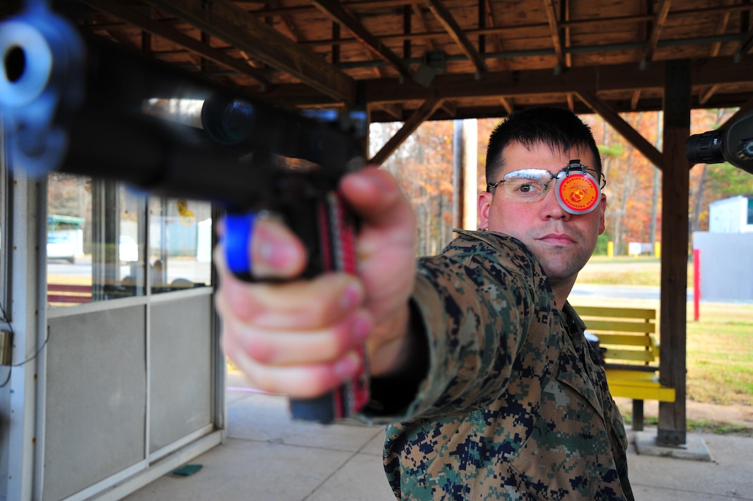 Staff Sgt. Jonathan Shue competitor/instructor, Marine Corps Shooting Team, dry fires his custom M1911 A1 National Match pistol at Weapons Training Battalion on Nov. 7, 2013. Shue is the first place winner of the North Carolina State Championship, pistol section with a score of 2643 out of 2700.