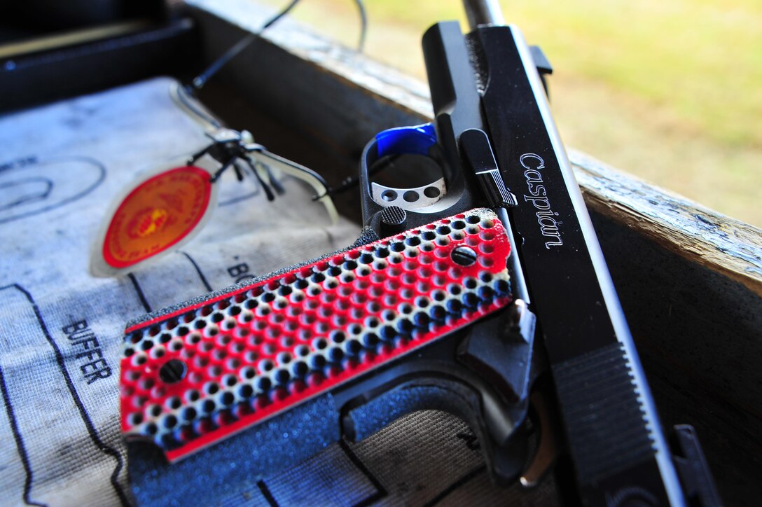 Staff Sgt. Jonathan Shue competitor/instructor, Marine Corps Shooting Team, dry fires his custom M1911 A1 National Match pistol at Weapons Training Battalion on Nov. 7, 2013. Shue is the first place winner of the North Carolina State Championship, pistol section with a score of 2643 out of 2700.