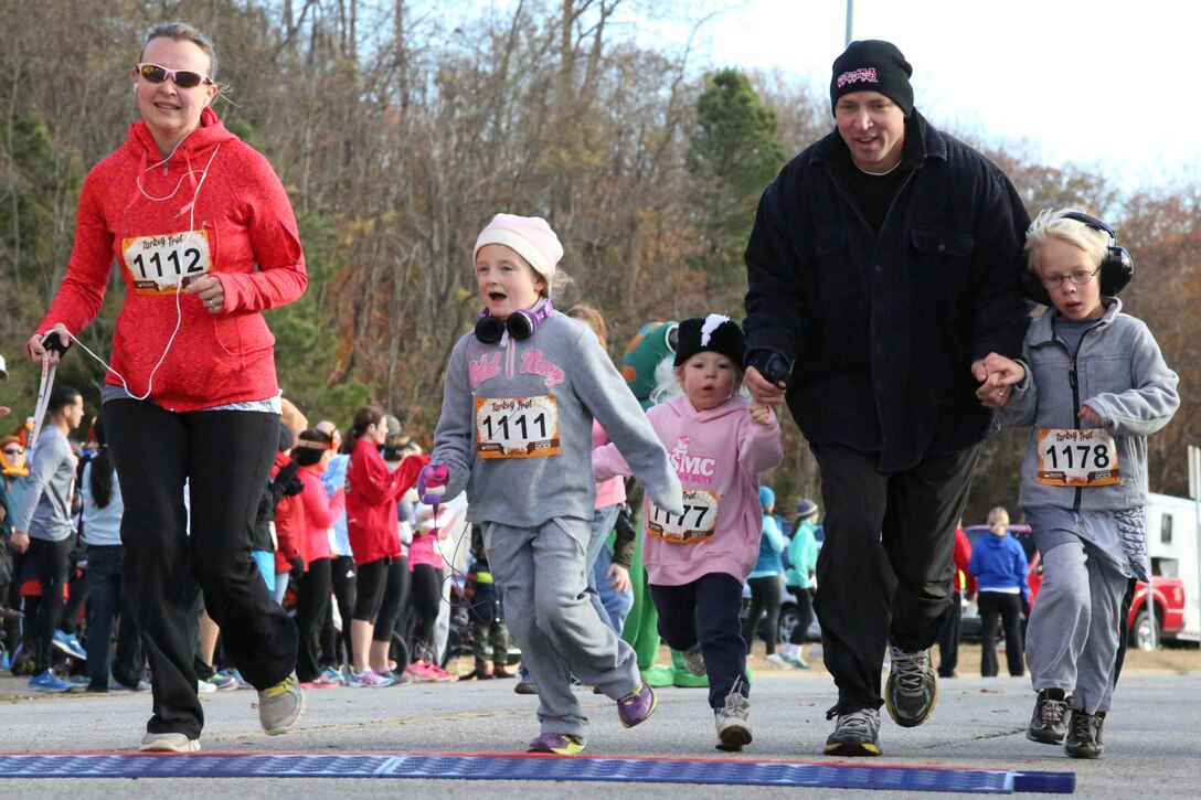 Participants cross the finish line during the Turkey Trot Mile aboard Marine Corps Base Quantico on Nov. 23, 2013. Around 300 people participated in the run. 