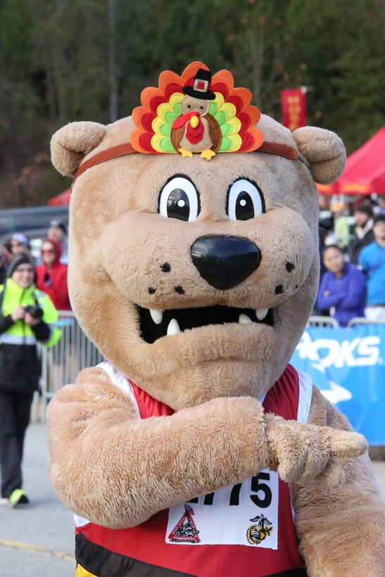 Miles, the Marine Corps Marathon mascot, motivates spectators during the Turkey Trot Mile aboard Marine Corps Base Quantico on Nov. 23, 2013. Over 1,000 people participated in the event. 