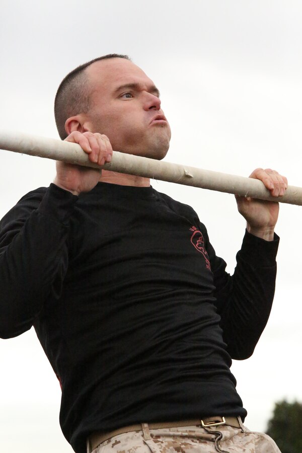 A Marine candidate participates in a pull up competition during a field meet at Officer Candidates School on Nov. 21, 2013. The field meet is one of the final events candidates participate in before graduation.
