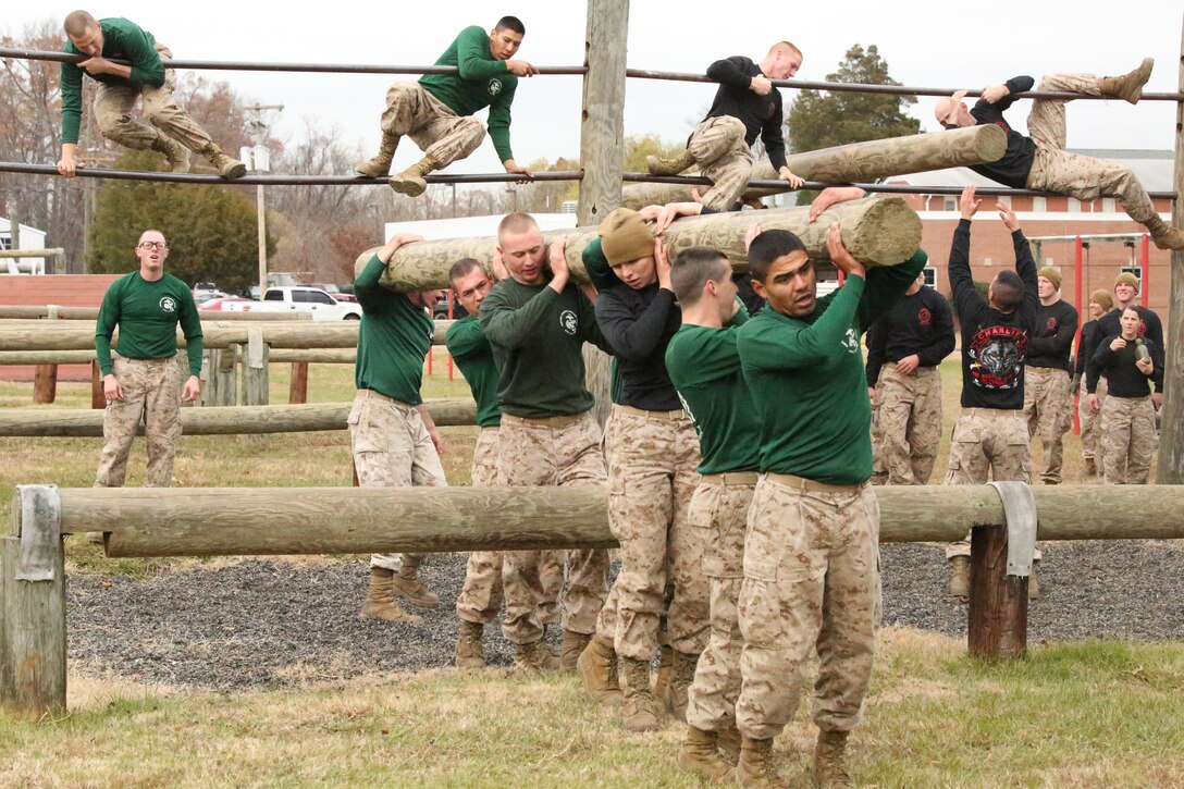 Marine candidates participate in an obstacle course during a field meet at Officer Candidates School on Nov. 21, 2013. The field meet is one of the final events candidates participate in before graduation.