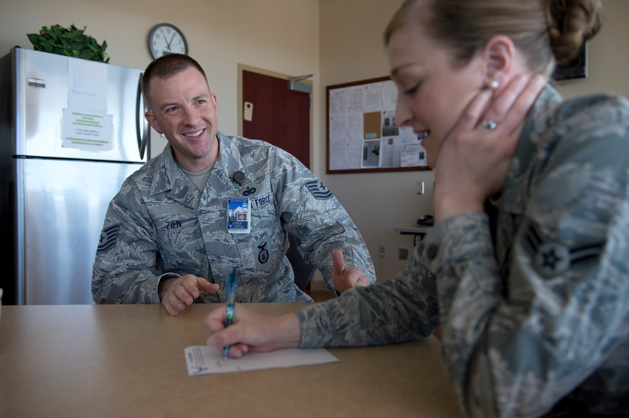 Tech. Sgt. Matthew Zien speaks with Airman 1st Class Christina Miller during a mentoring session Nov. 14, 2013, at the VA Joint Venture Buckley Clinic at Buckley Air Force Base, Colo. Zien makes a point to spend time with Airmen, providing mentoring advice on Air Force issues.. Zien, a former MTI, is currently a patient, but voluntarily works a full schedule for the clinic. Miller is an aerospace medical services apprentice at the same clinic.