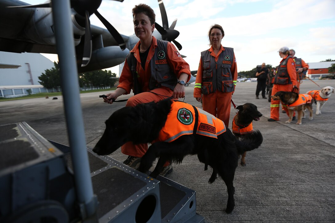 A search and rescue team from Edmonton, Canada, boards a KC-130J Super Hercules aircraft with Marine Aerial Refueler Transport Squadron 152 (VMGR-152), Marine Aerial Refueler Transport Squadron 152 (VMGR-152), currently assigned to 3rd Marine Expeditionary Brigade in support of Joint Task Force 505, at Villamor Air Base, Nov. 19, 2013. The search and rescue team arrived to Republic of the Philippines to search for survivors affected by Typhoon Haiyan in support of the disaster relief Operation Damayan.