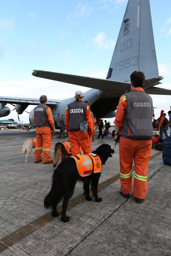 A search and rescue team from Edmonton, Canada, waits to board a KC-130J Super Hercules aircraft with Marine Aerial Refueler Transport Squadron 152 (VMGR-152), currently assigned to 3rd Marine Expeditionary Brigade in support of Joint Task Force 505, at Villamor Air Base, Nov. 19, 2013. The search and rescue team arrived to Republic of the Philippines to search for survivors affected by Typhoon Haiyan in support of the disaster relief Operation Damayan.