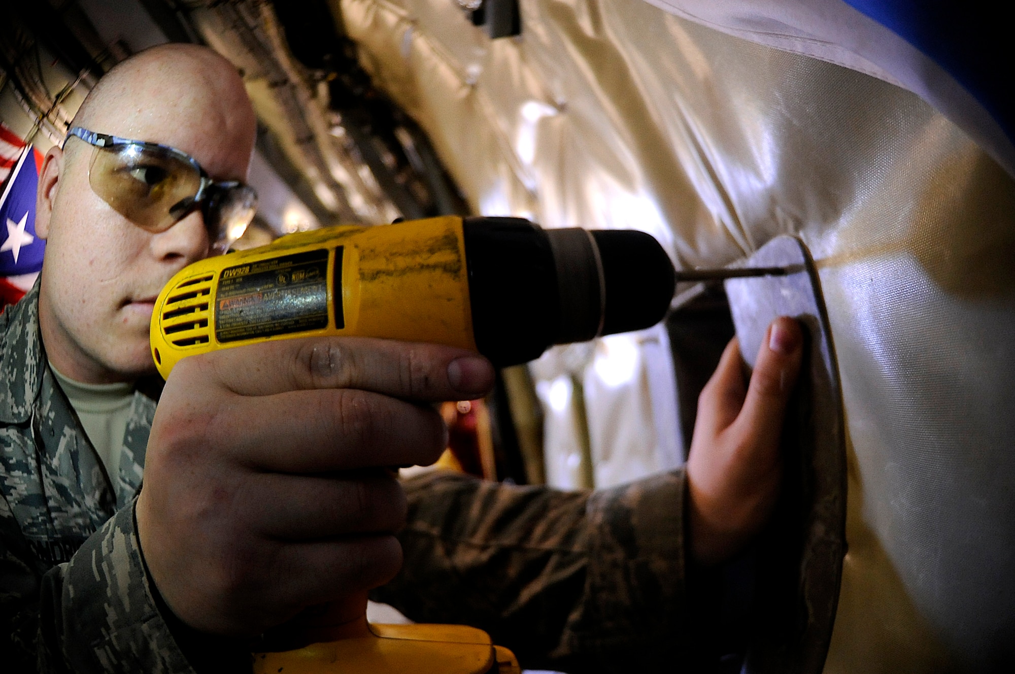 U.S. Air Force Staff Sgt. Aaron Hondrick, 18th Equipment Maintenance Squadron aircraft structural maintenance technician and Montana native, drills holes into a newly repaired fiberglass KC-135 Stratotanker component on Kadena Air Base, Japan, Nov. 20, 2013. As aircraft parts bend, break or corrode over time, the Airmen from the Aircraft Structural Maintenance flight step in to repair or replace the faulty equipment -- often saving the Air Force thousands of dollars in the process. Whether it's replacing a $3 bolt or repairing a $1.5 million KC-135 Stratotanker aileron, the Aircraft Structural Maintenance flight gives the U.S. Air Force an unmatched reach and presence in the Asia Pacific Region and is vital to the successful mission of the 18th Wing. (U.S. Air Force photo by Senior Airman Maeson L. Elleman)