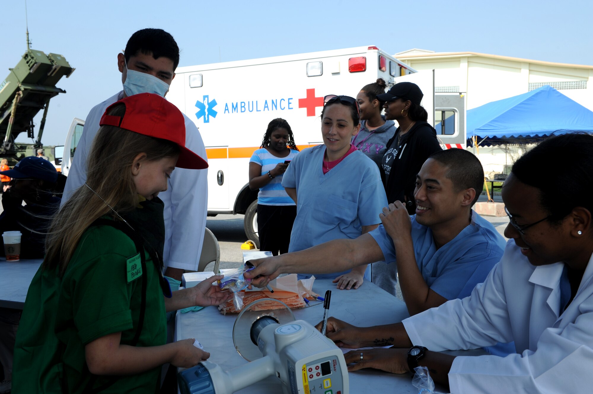The 18th Dental Squadron processes a Skoshi Warrior participant as part of the processing line during Skoshi Warrior on Kadena Air Base, Japan, Nov. 23, 2013. Many units, such as the Military Personnel Section, Dental Squadron, Public Health Clinic, Legal Office and finance office were part of the processing line and provided information to participants as part of their mock deployment. (U.S. Air Force photo by Airman 1st Class Hailey R. Davis)