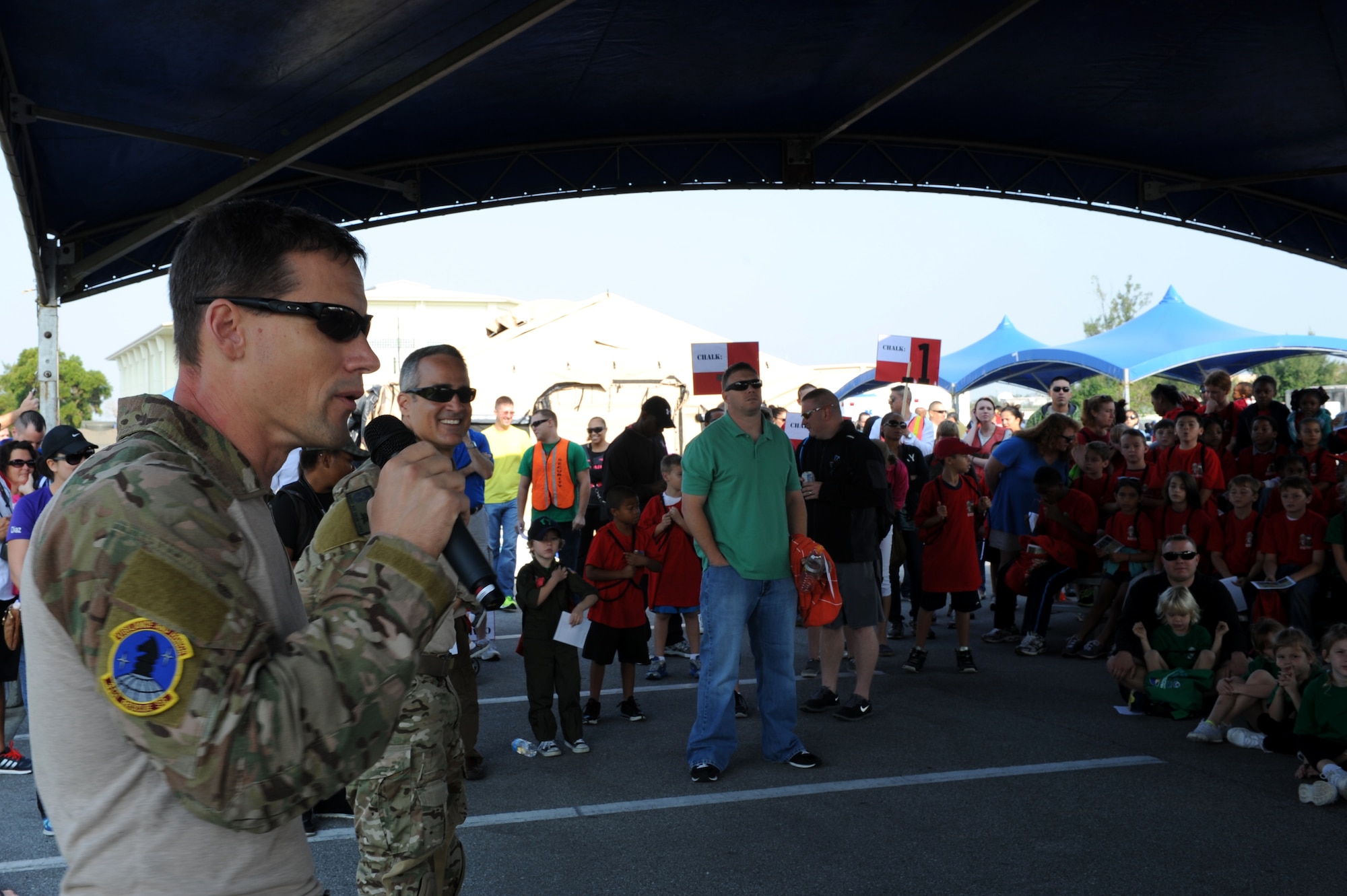 U.S. Air Force Col. Pete Milohnic, 18th Operations Group commander, provides opening remarks at Kadena's Skoshi Warrior event on Kadena Air Base, Japan, Nov. 23, 2013. Skoshi Warrior is an annual event for children of military members and provides a fun environment for children to experience aspects of the deployment process their parents go through when they are tasked to deploy. (U.S. Air Force photo by Airman 1st Class Hailey R. Davis)