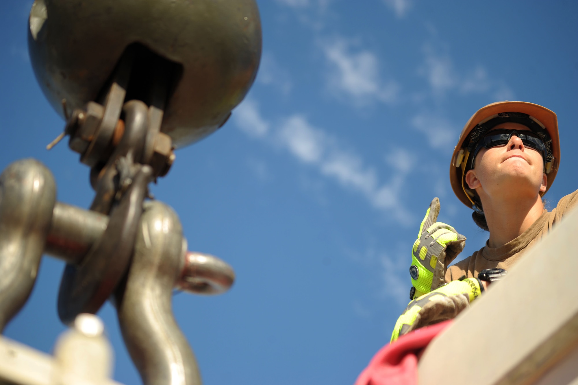Equipment Operator 2nd Class Renee Harrison, assigned to Naval Mobile Construction Battalion (NMCB) 3's crane crew, directs the operator of a 40-ton hydraulic crane while replacing a 6,000-pound transformer used to power portions of Kadena Air Base, Okinawa, Japan, Nov. 21, 2013. NMCB 3 provides combatant commanders and Navy component commanders with combat-ready warfighters capable of general engineering, construction and limited combat engineering across the full range of military operations. (U.S. Navy photo by Mass Communication Specialist 1st Class Chris Fahey)