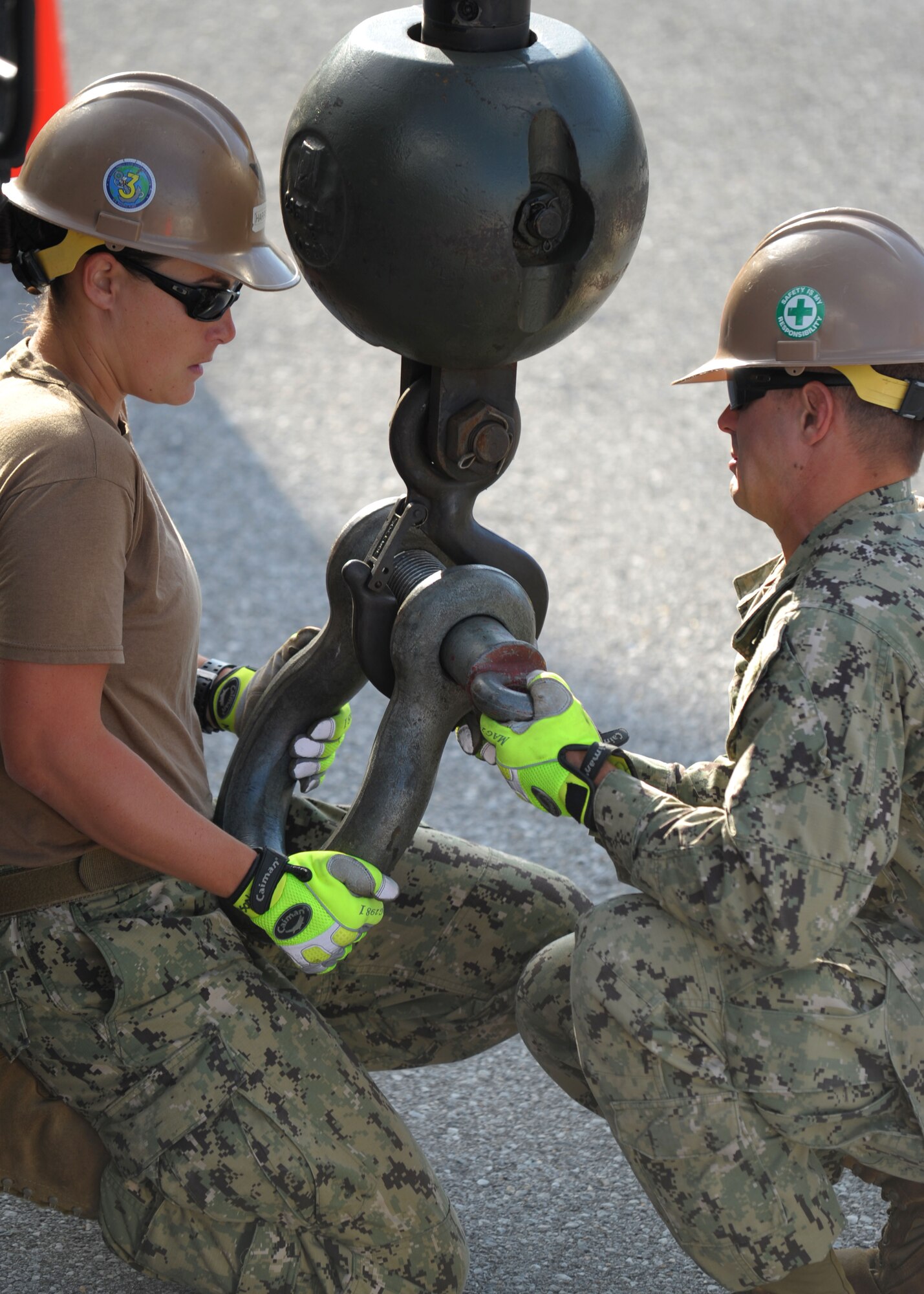 Equipment Operator 2nd Classes Renee Harrison, left, and Charles Post, both assigned to Naval Mobile Construction Battalion (NMCB) 3's crane crew, secure the rigging shoe of a 40-ton hydraulic crane before replacing a 6,000-pound transformer used to power portions of Kadena Air Base, Japan, Nov. 21, 2013. One of the first battalions commissioned during World War II, NMCB 3's legacy stands strong in its ability to build and fight anywhere in the world as either a full battalion or as a group of autonomous detachments, simultaneously completing critical engineering and construction missions. For this deployment, NMCB 3 has split into nine details to perform critical construction projects in remote island areas such as Timor-Leste, Tonga, Cambodia and the Philippines. The teams will also conduct operations in Atsugi, Yokosuka and Okinawa, Japan; Chinhae, Republic of Korea and China Lake, Calif. The Naval Construction Force is a vital component of the U.S. Maritime Strategy. They provide deployable battalions capable of providing disaster preparation and recovery support, humanitarian assistance and combat operations support. NMCB 3 provides combatant commanders and Navy component commanders with combat-ready warfighters capable of general engineering, construction and limited combat engineering across the full range of military operations. (U.S. Navy photo by Mass Communication Specialist 1st Class Chris Fahey)