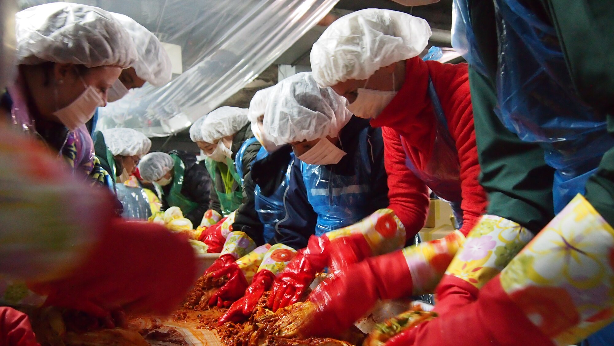 PYONGTAEK, Republic of Korea - Seventh Air Force volunteers make kimchi during the Pyongtaek Kimchi-Making Festival in the basement of the Pyongtaek City Hall Nov. 23, 2013. More than 50 members of the 7th Air Force Airpower Team joined with 200 Korean volunteers to make kimchi for the less fortunate. Kimchi is a traditional Korean side dish made of fermented vegetables mixed with spices. (U.S. Air Force photo by Tech. Sgt. Thomas J. Doscher)