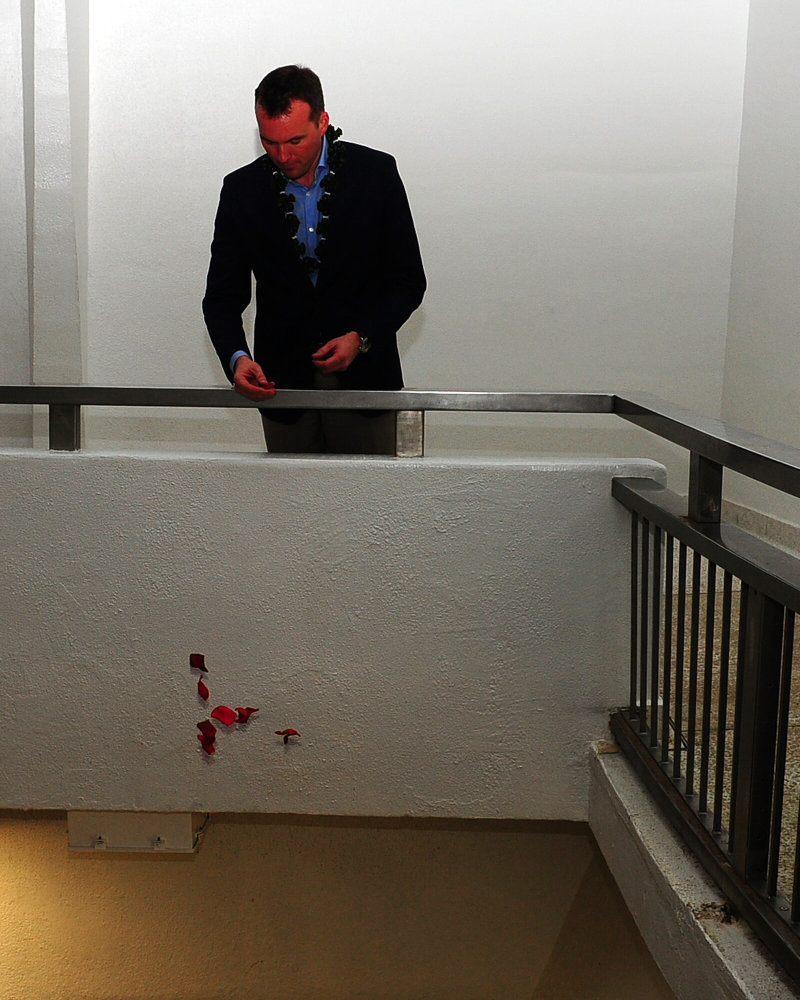 Acting Secretary of the Air Force Eric Fanning tosses rose petals into the well at the USS Arizona Memorial, Pearl Harbor, Hawaii, Nov. 23, 2013, in remembrance of those servicemembers who died during the attack on Pearl Harbor on Dec. 7, 1941. The secretary was hosted by Gen. Hawk Carlisle, Pacific Air Forces commander. During his visit, Fanning met with PACAF leaders, visited the 613th Air Operations Center, received a command briefing, attended an F-111 dedication ceremony at the Pacific Aviation Museum, and visited the USS Arizona Memorial. (U.S. Air Force photo/Tech. Sgt. LuCelia Ball)